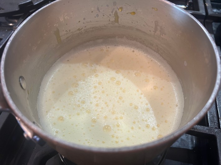 Custard thickens in a saucepan.