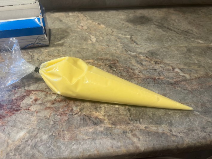 Lemon curd in a piping bag.