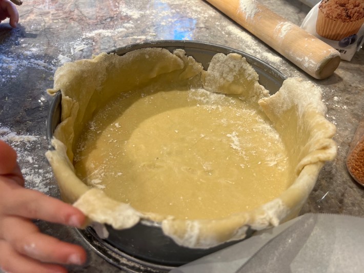 Tart dough fit into a tart pan.