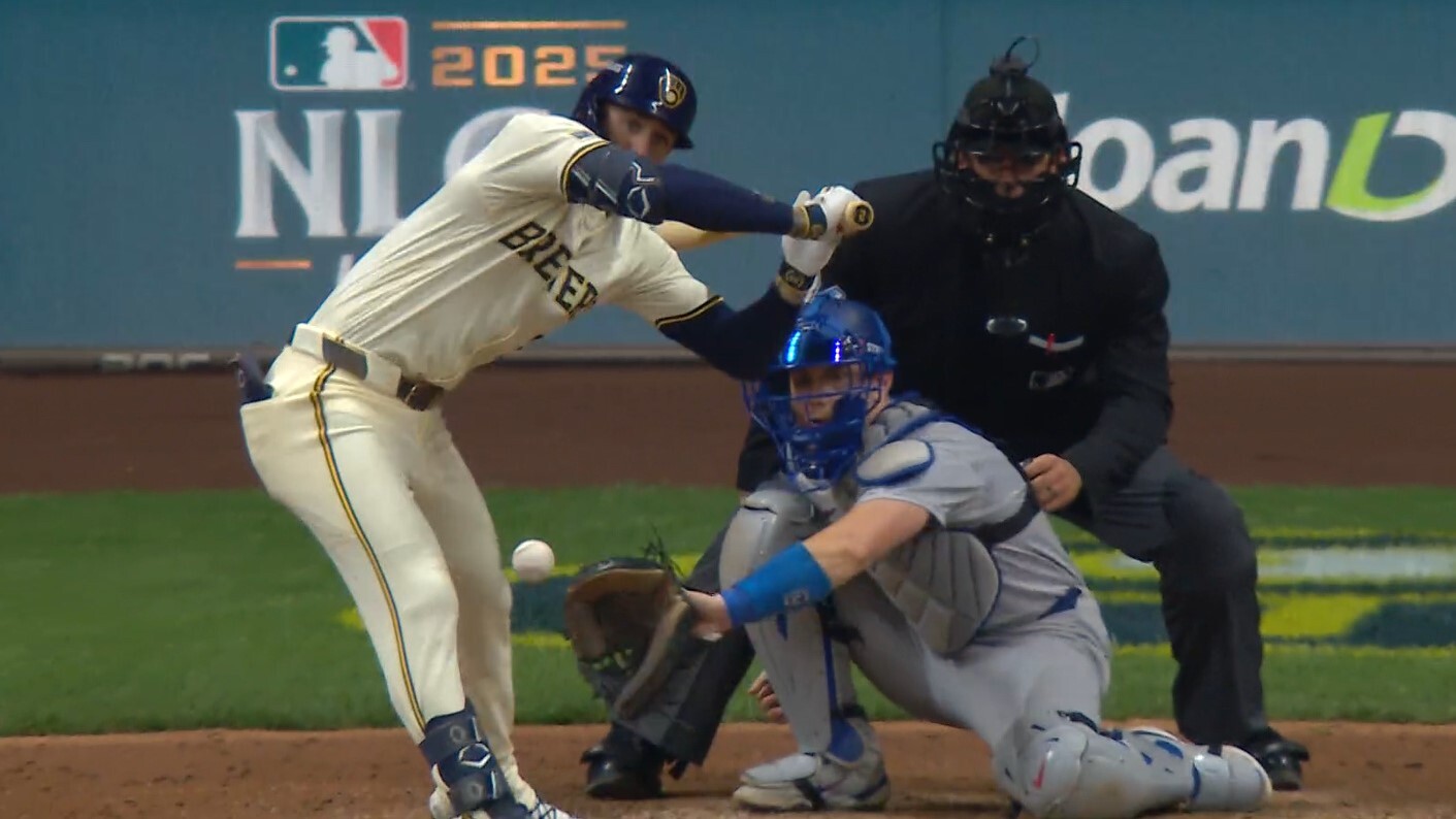 Brice Turang dodges a ball at the knees