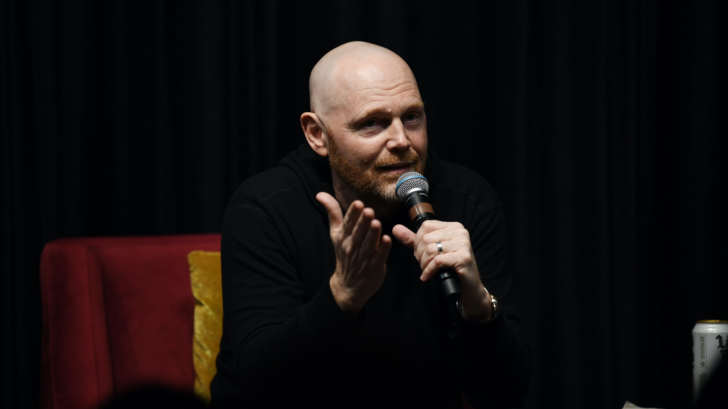 Bill Burr talking into a microphone.