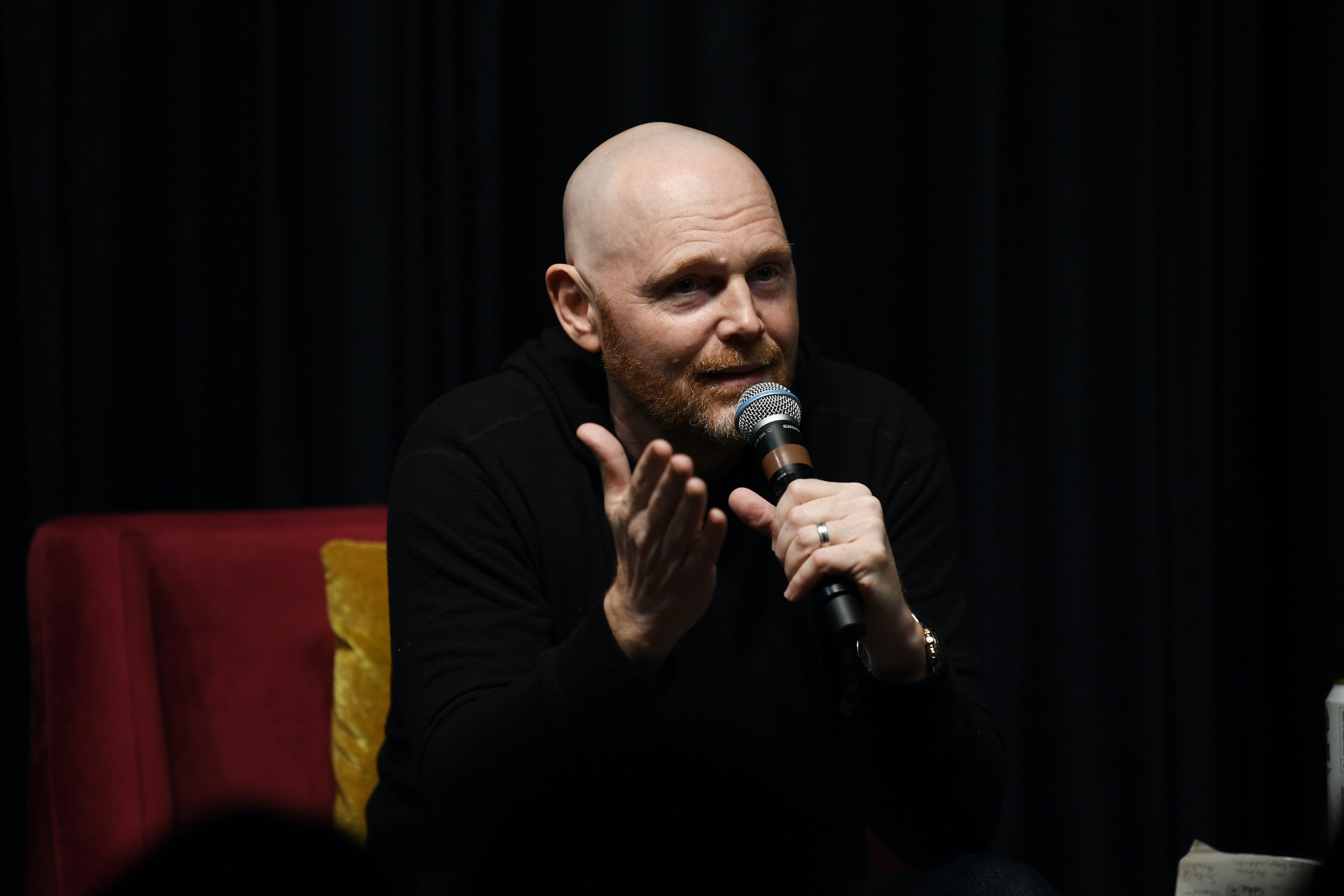 Bill Burr talking into a microphone.