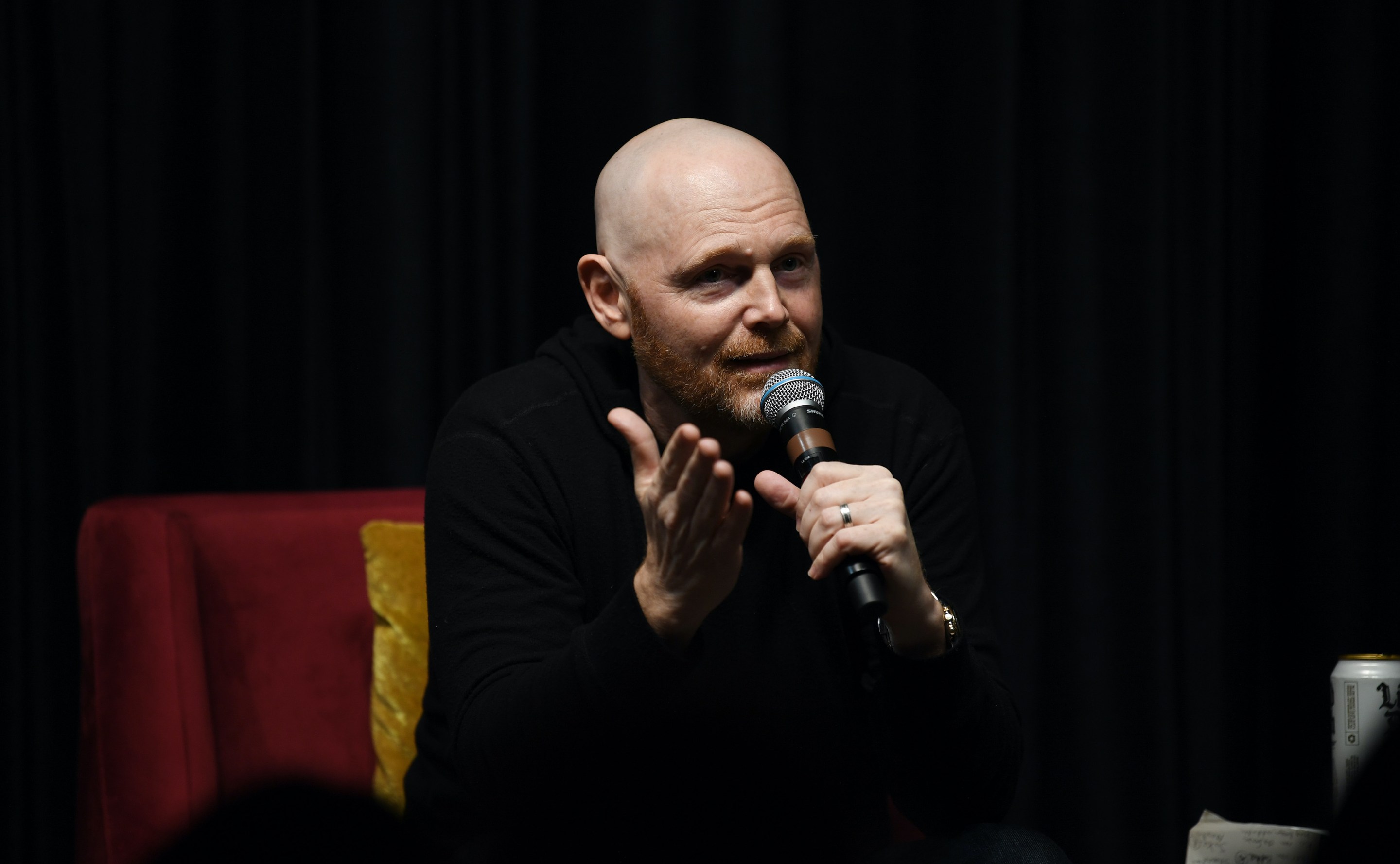 Bill Burr talking into a microphone.