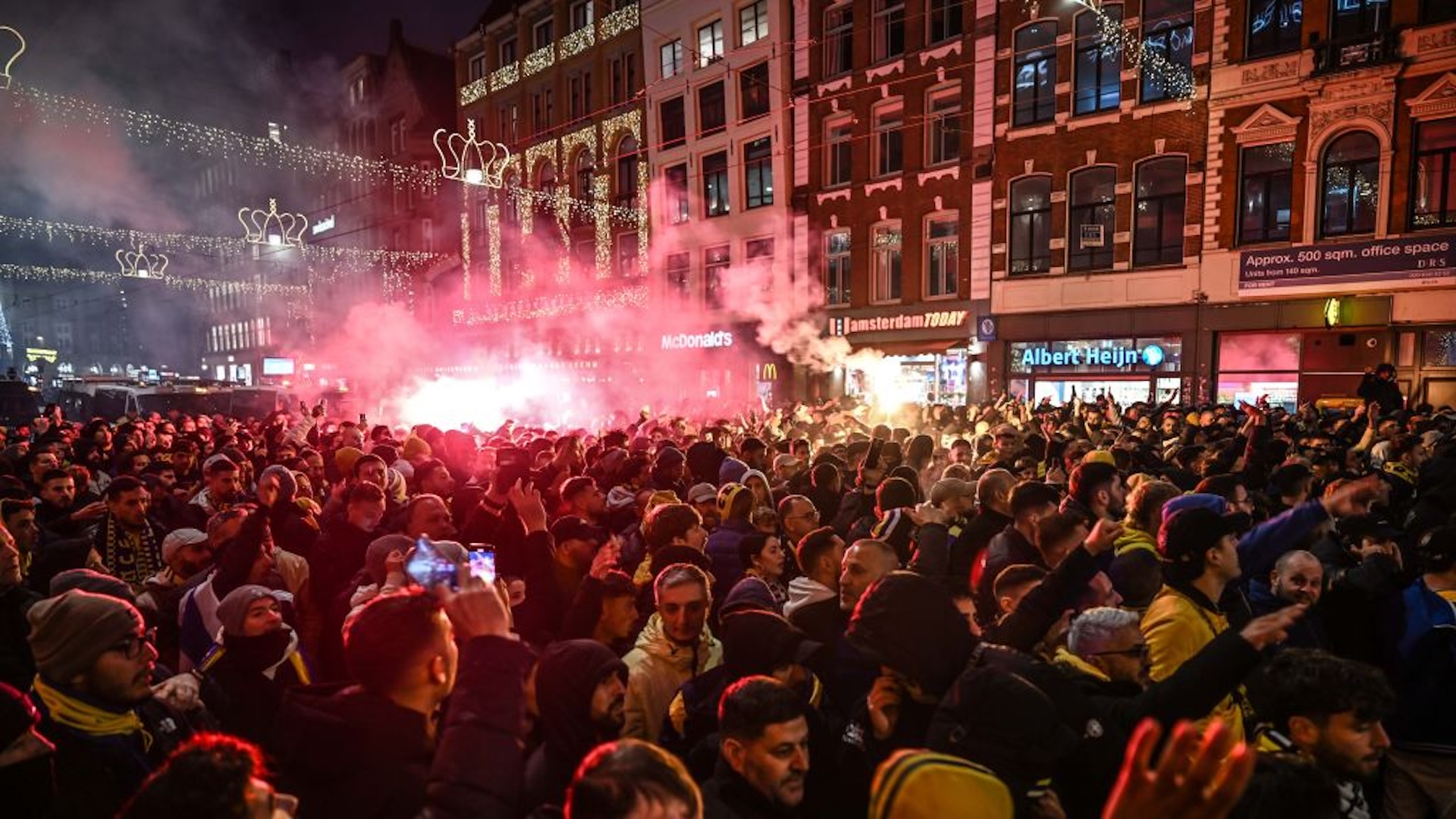 Fans of Maccabi Tel Aviv stage a pro-Israel demonstration at the Dam Square, lighting up flares and chanting slogans ahead of the UEFA Europa League match between Maccabi Tel Aviv and Ajax in Amsterdam, Netherlands on November 07, 2024. Maccabi fans clashed with pro-Palestinian citizens and ripped off Palestinian flags hung on the streets. In the lead-up to the Ajax vs Maccabi Tel Aviv match, several areas of Amsterdam have been designated as security risk zones.