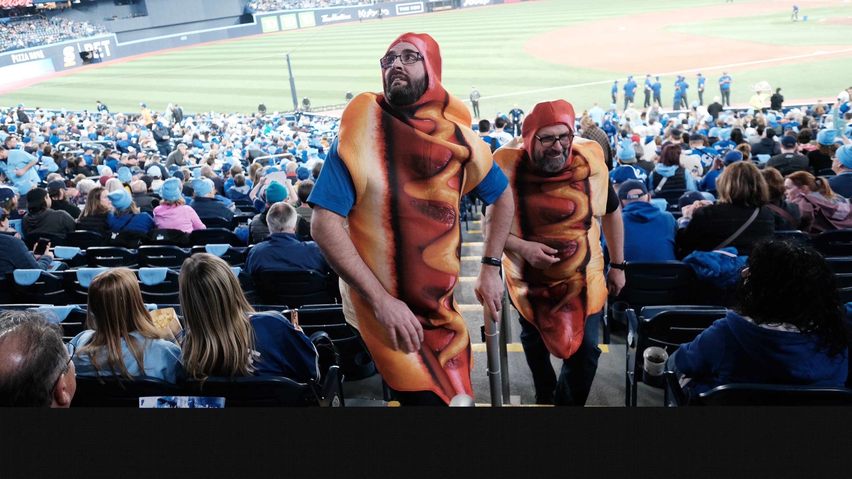 Hot Dog Guys or Loonie Dog Kings Jody Matheson (r) and Ryan Ruston ( l) get welcomed back to the park and looking forward to loonie dogs. This was taken on the day of the Toronto Blue Jays' 2025 home opener.