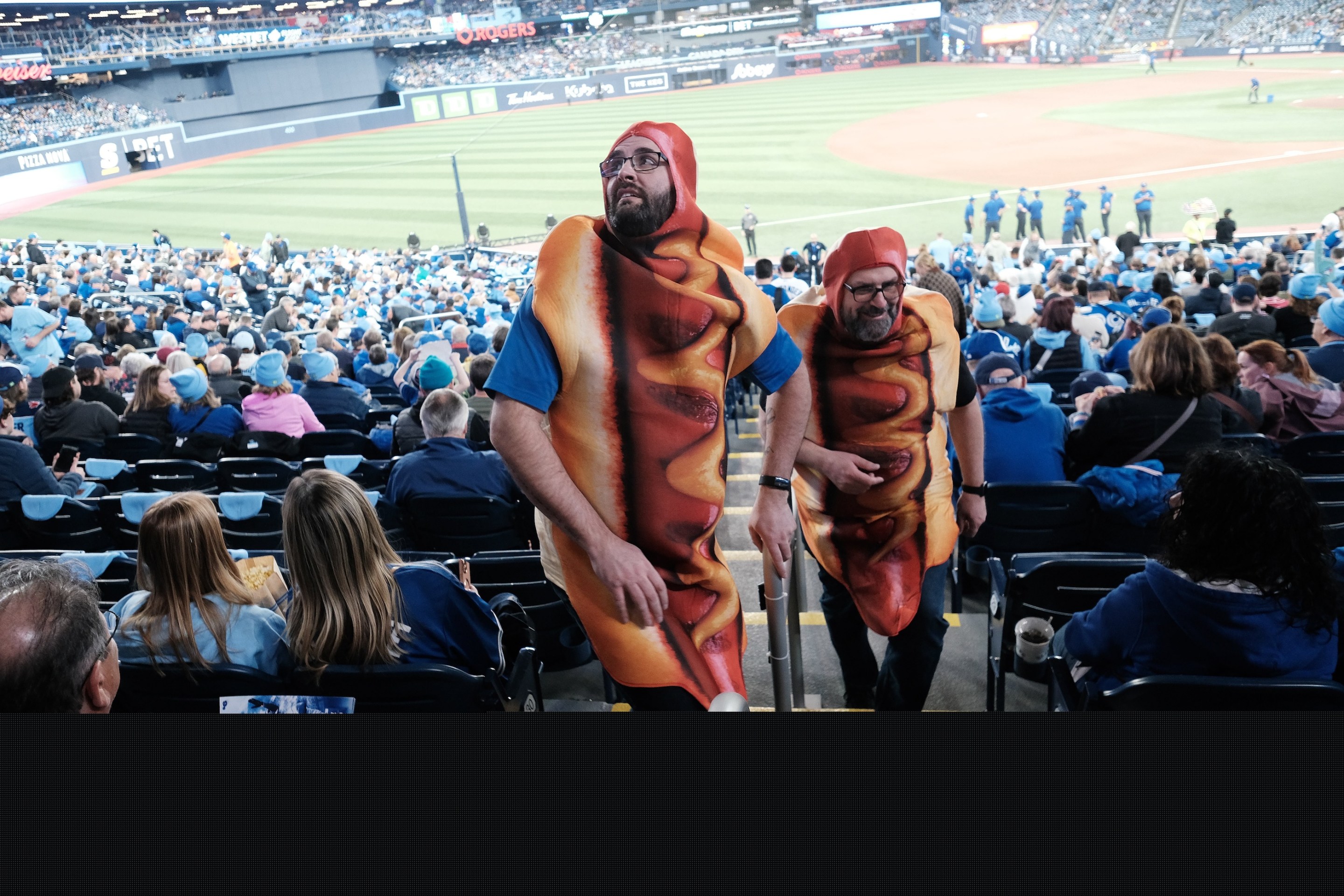 Hot Dog Guys or Loonie Dog Kings Jody Matheson (r) and Ryan Ruston ( l) get welcomed back to the park and looking forward to loonie dogs. This was taken on the day of the Toronto Blue Jays' 2025 home opener.