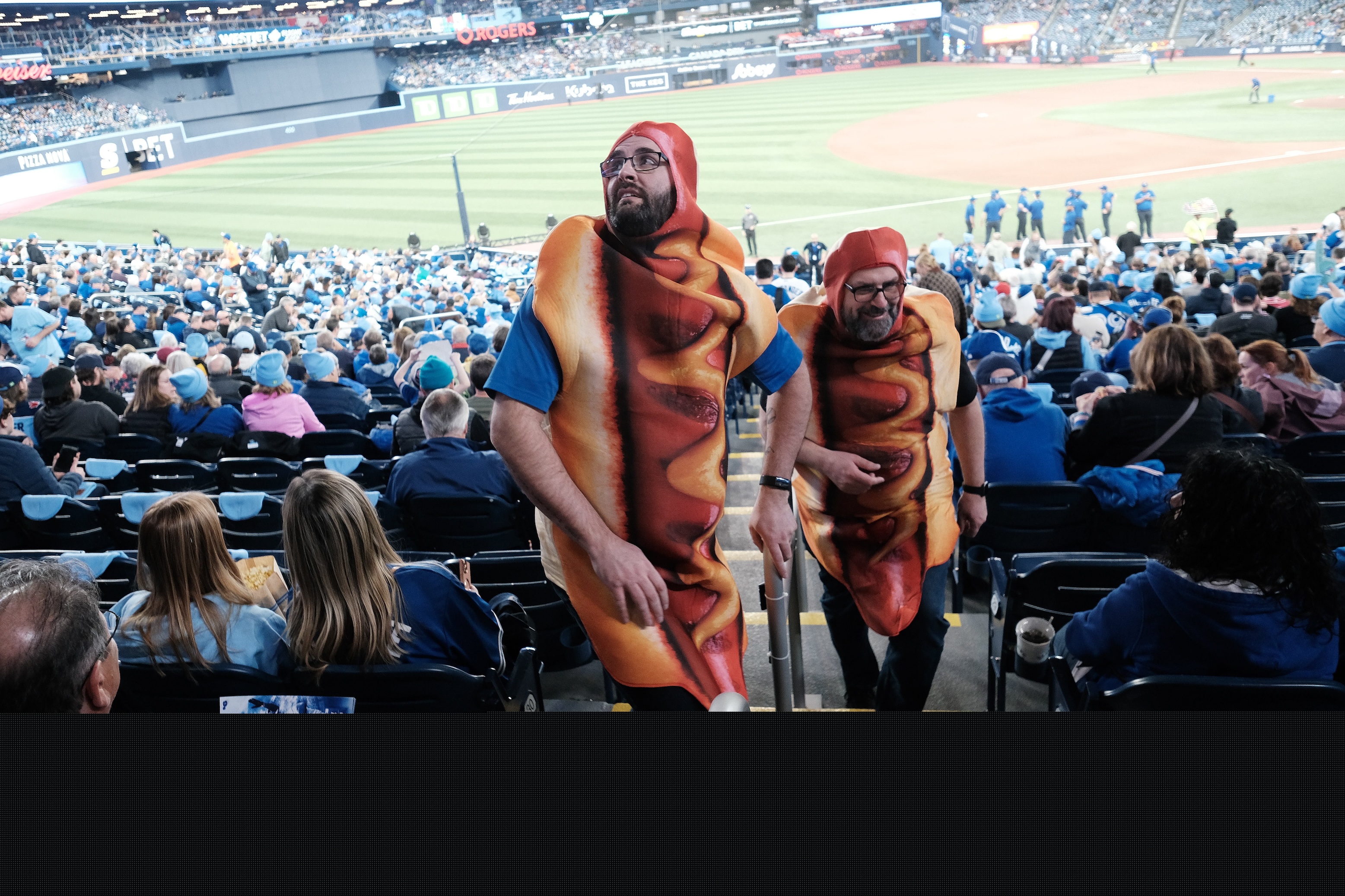 Hot Dog Guys or Loonie Dog Kings Jody Matheson (r) and Ryan Ruston ( l) get welcomed back to the park and looking forward to loonie dogs. This was taken on the day of the Toronto Blue Jays' 2025 home opener.