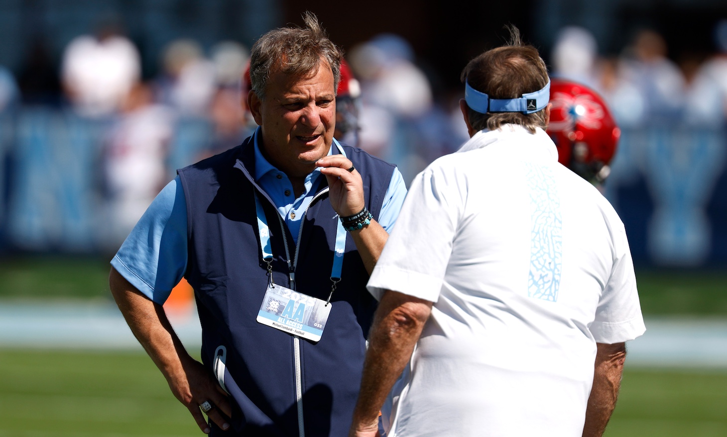 General manager Michael Lombardi talks with head coach Bill Belichick of the North Carolina Tar Heels prior to the game against the Richmond Spiders at Kenan Memorial Stadium on September 13, 2025 in Chapel Hill, North Carolina.