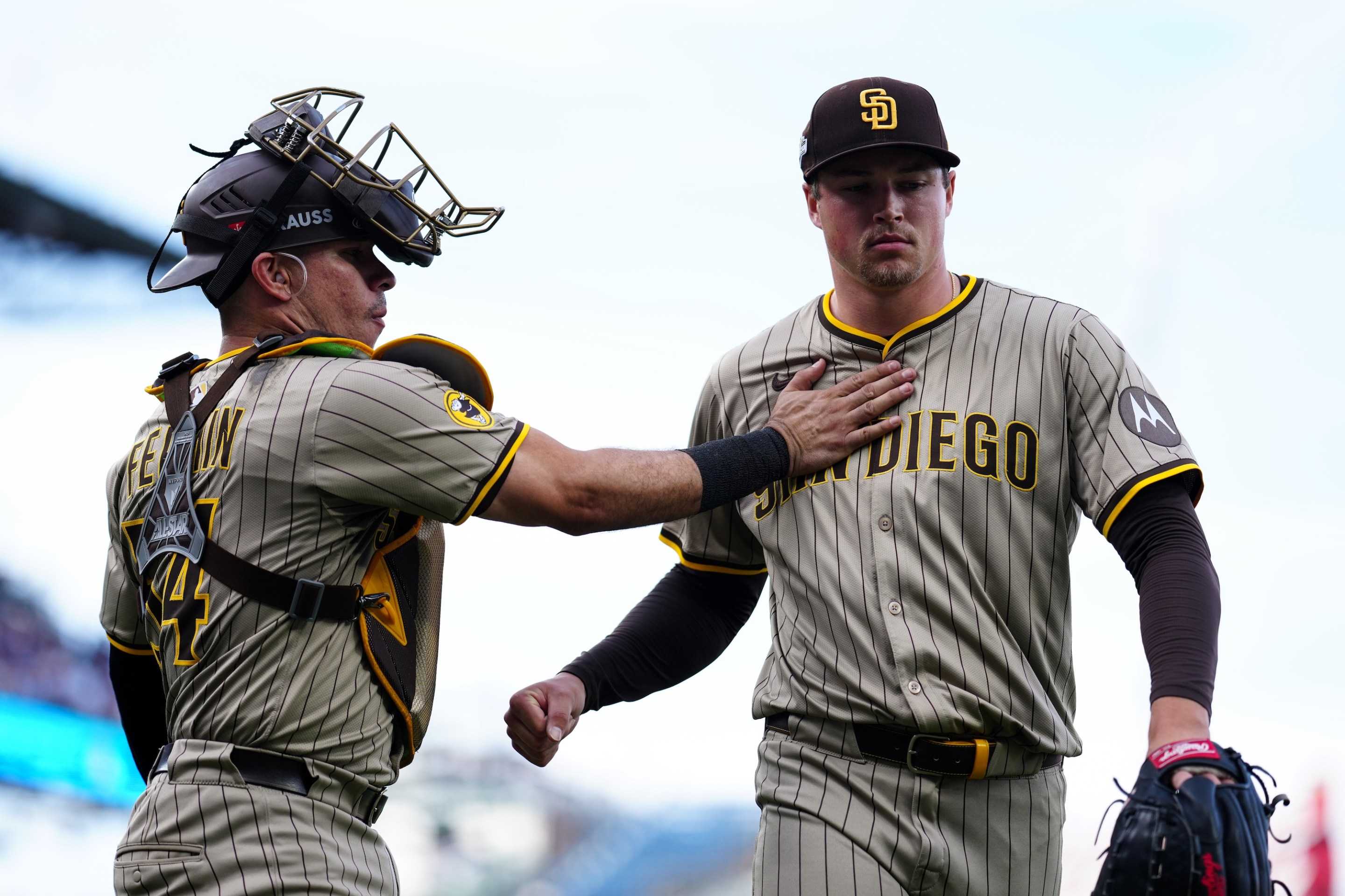 CHICAGO, IL - OCTOBER 01: Freddy Fermin #54 and Mason Miller #22 of the San Diego Padres interact during Game Two of the National League Wild Card Series between the San Diego Padres and the Chicago Cubs at Wrigley Field on Wednesday, October 1, 2025 in Chicago, Illinois. (Photo by Mary DeCicco/MLB Photos via Getty Images)