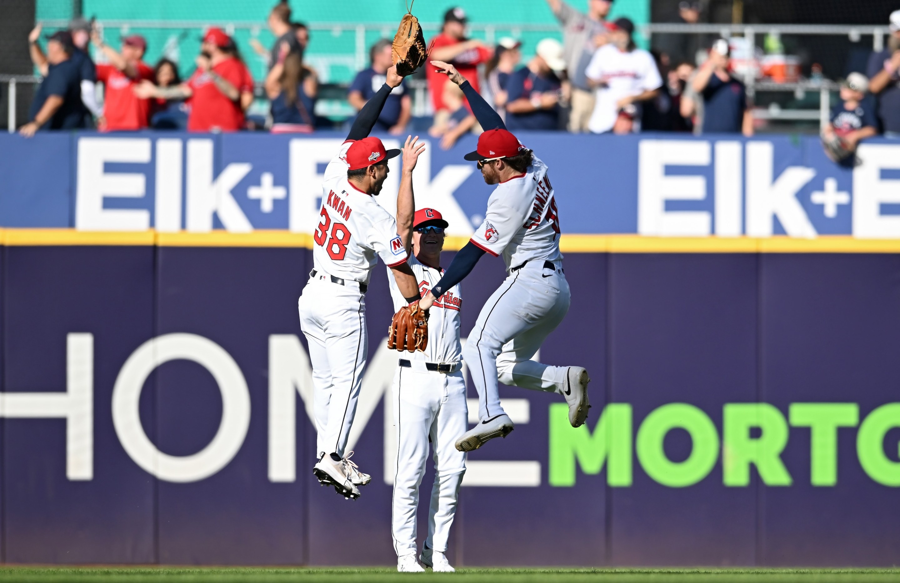 CLEVELAND, OHIO - OCTOBER 01: Steven Kwan #38, Petey Halpin #0, and Daniel Schneemann #10 of the Cleveland Guardians celebrate after beating the Detroit Tigers 6-1 in game two of the American League Wild Card Series at Progressive Field on October 01, 2025 in Cleveland, Ohio. (Photo by Nick Cammett/Getty Images)