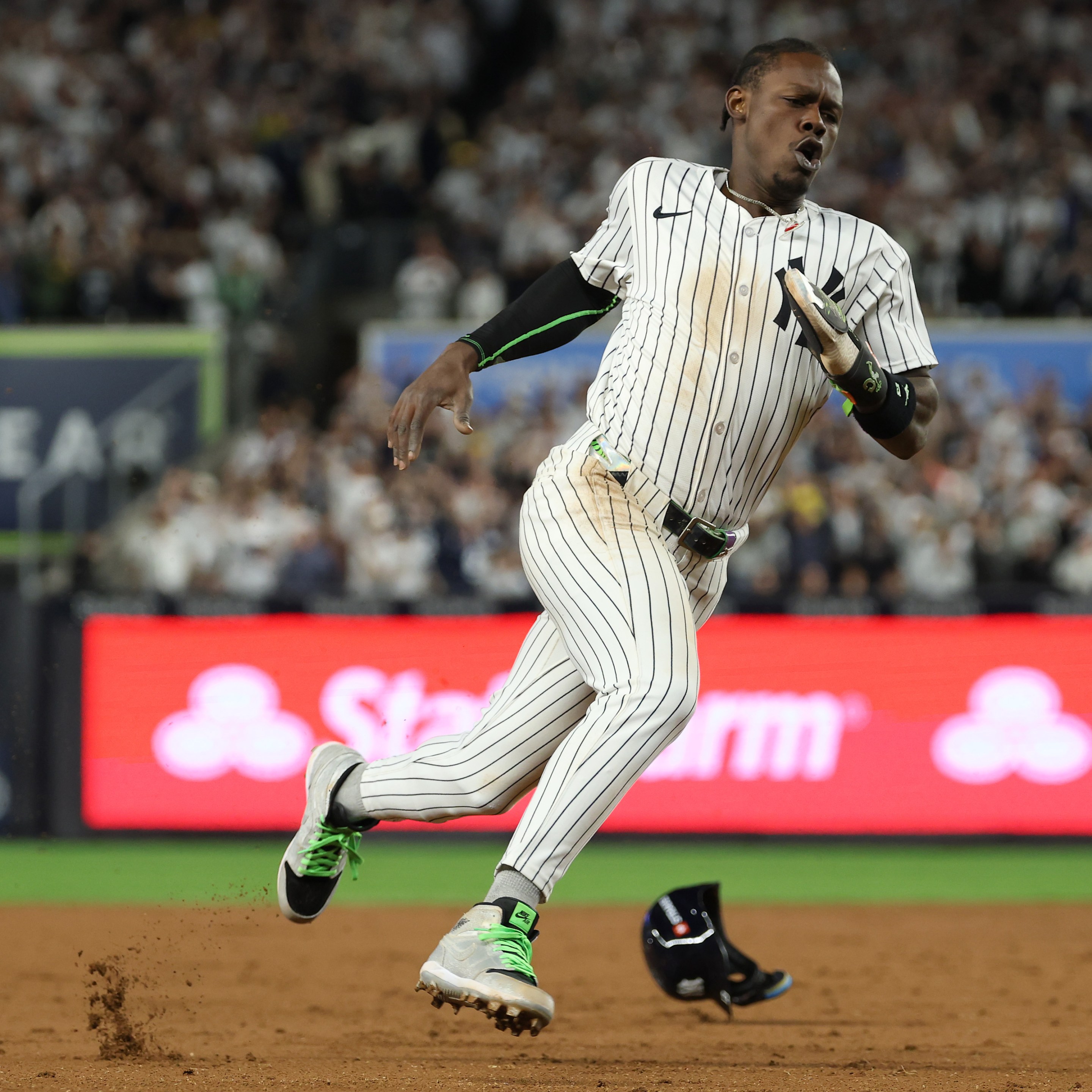 Jazz Chisholm Jr. #13 of the New York Yankees rounds third base to score a go-ahead run
