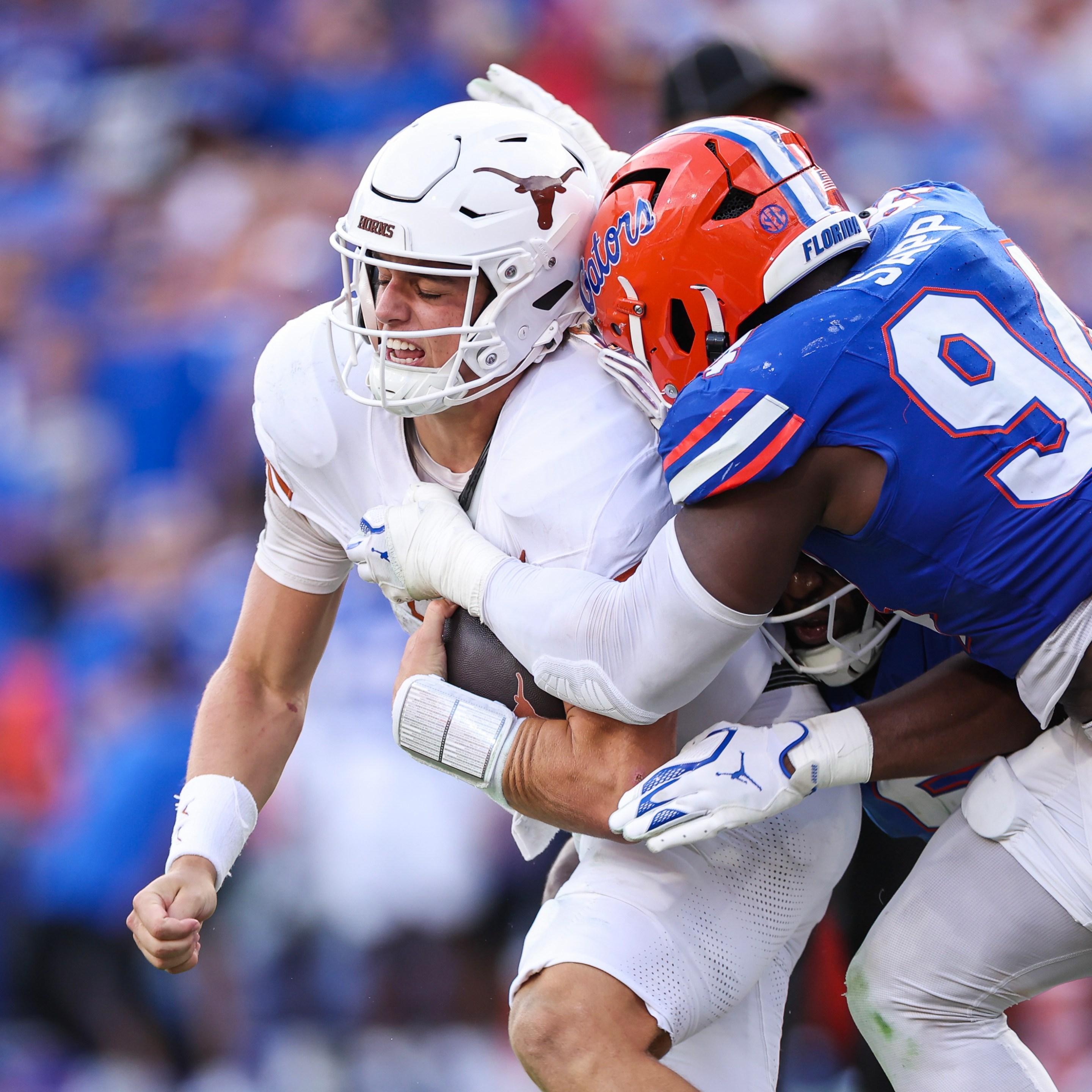 A Florida Gator tackles a Texas Longhorn in a college football game.