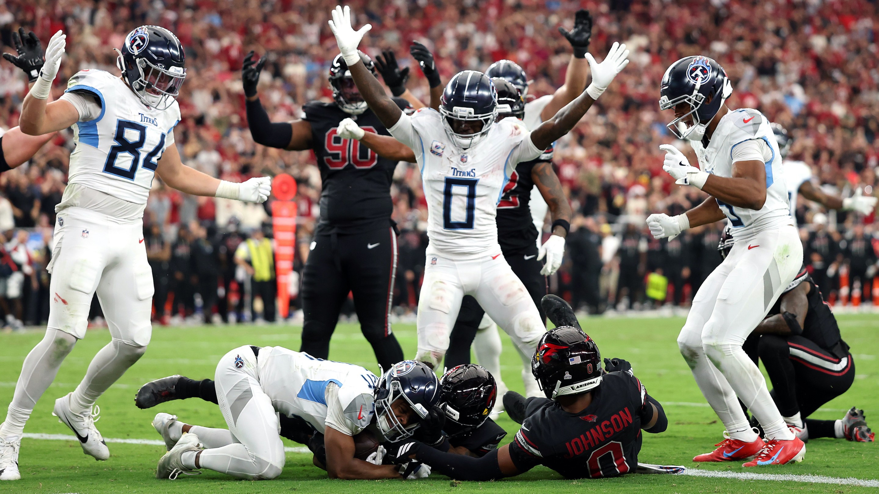 Tyler Lockett #4 of the Tennessee Titans recovers a fumble for a touchdown in front of Budda Baker #3 of the Arizona Cardinals during the fourth quarter