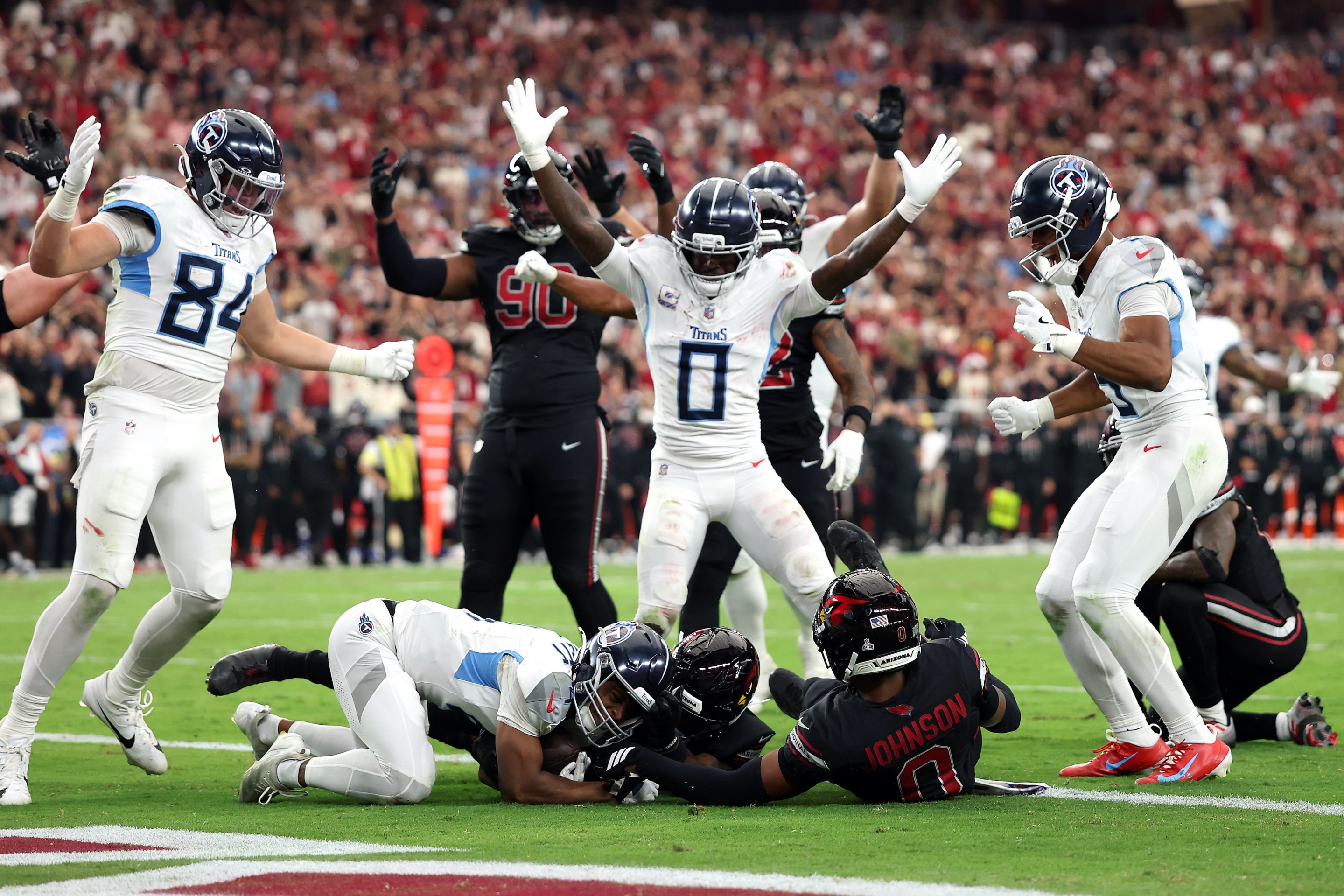 Tyler Lockett #4 of the Tennessee Titans recovers a fumble for a touchdown in front of Budda Baker #3 of the Arizona Cardinals during the fourth quarter