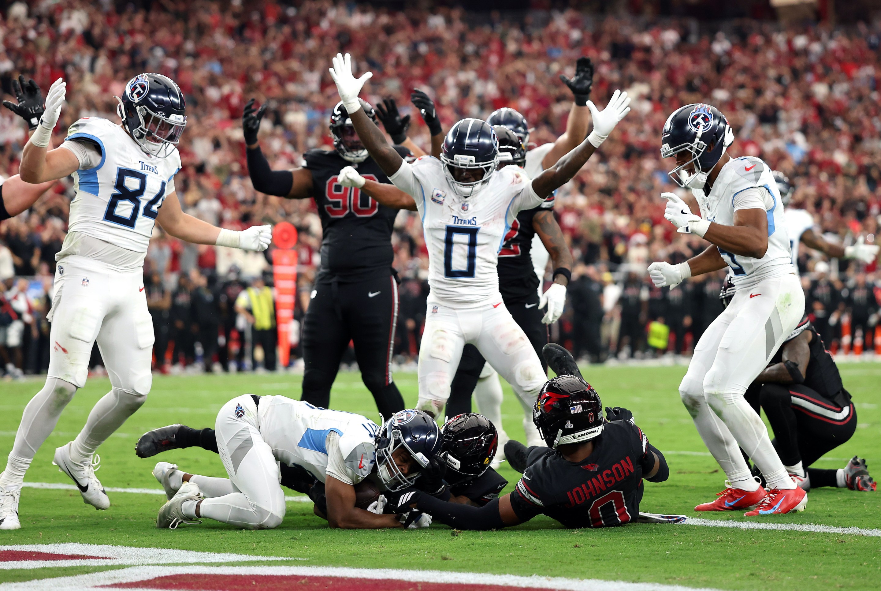 Tyler Lockett #4 of the Tennessee Titans recovers a fumble for a touchdown in front of Budda Baker #3 of the Arizona Cardinals during the fourth quarter