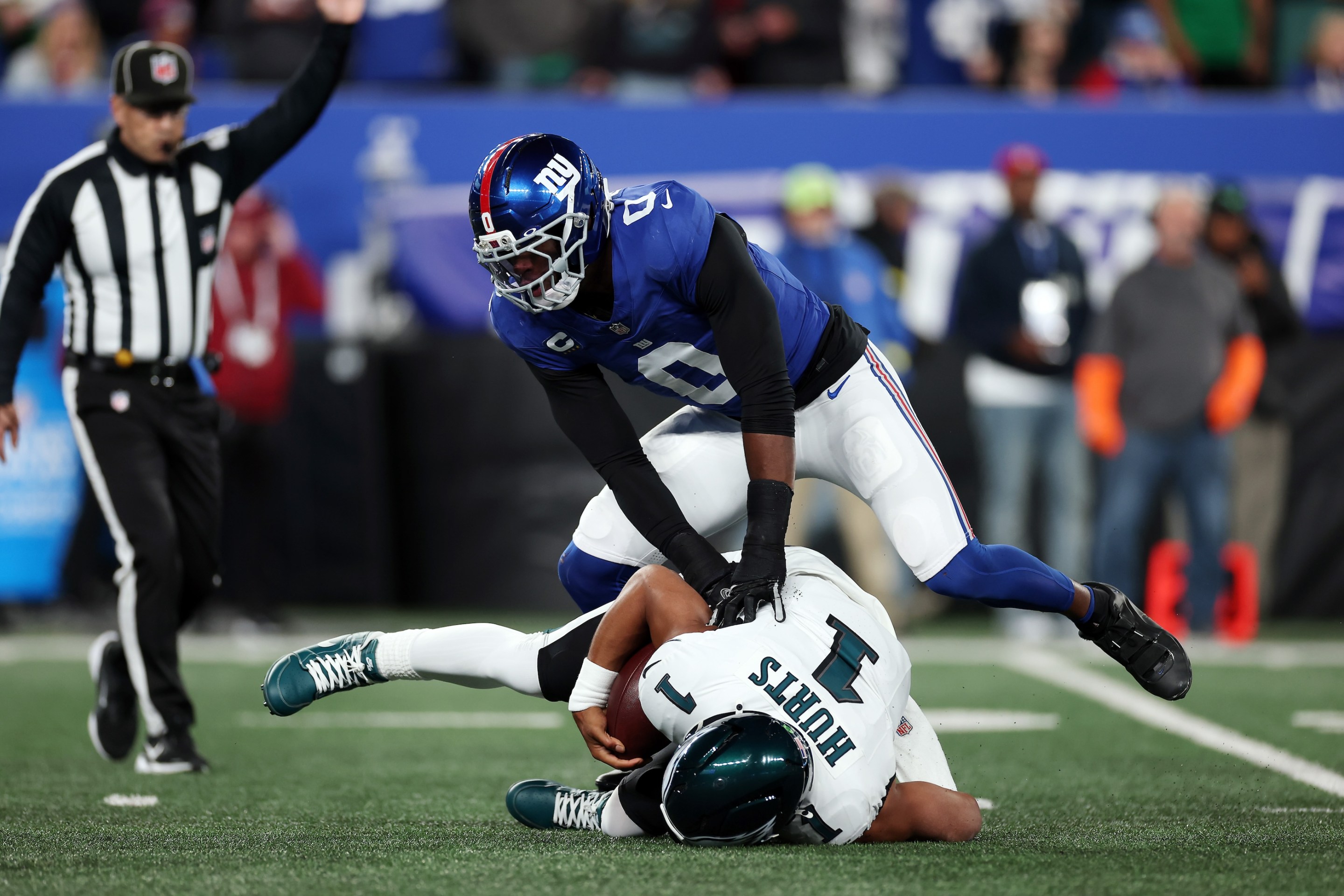 Linebacker Brian Burns #0 of the New York Giants sacks quarterback Jalen Hurts #1 of the Philadelphia Eagles on 10/9/25.