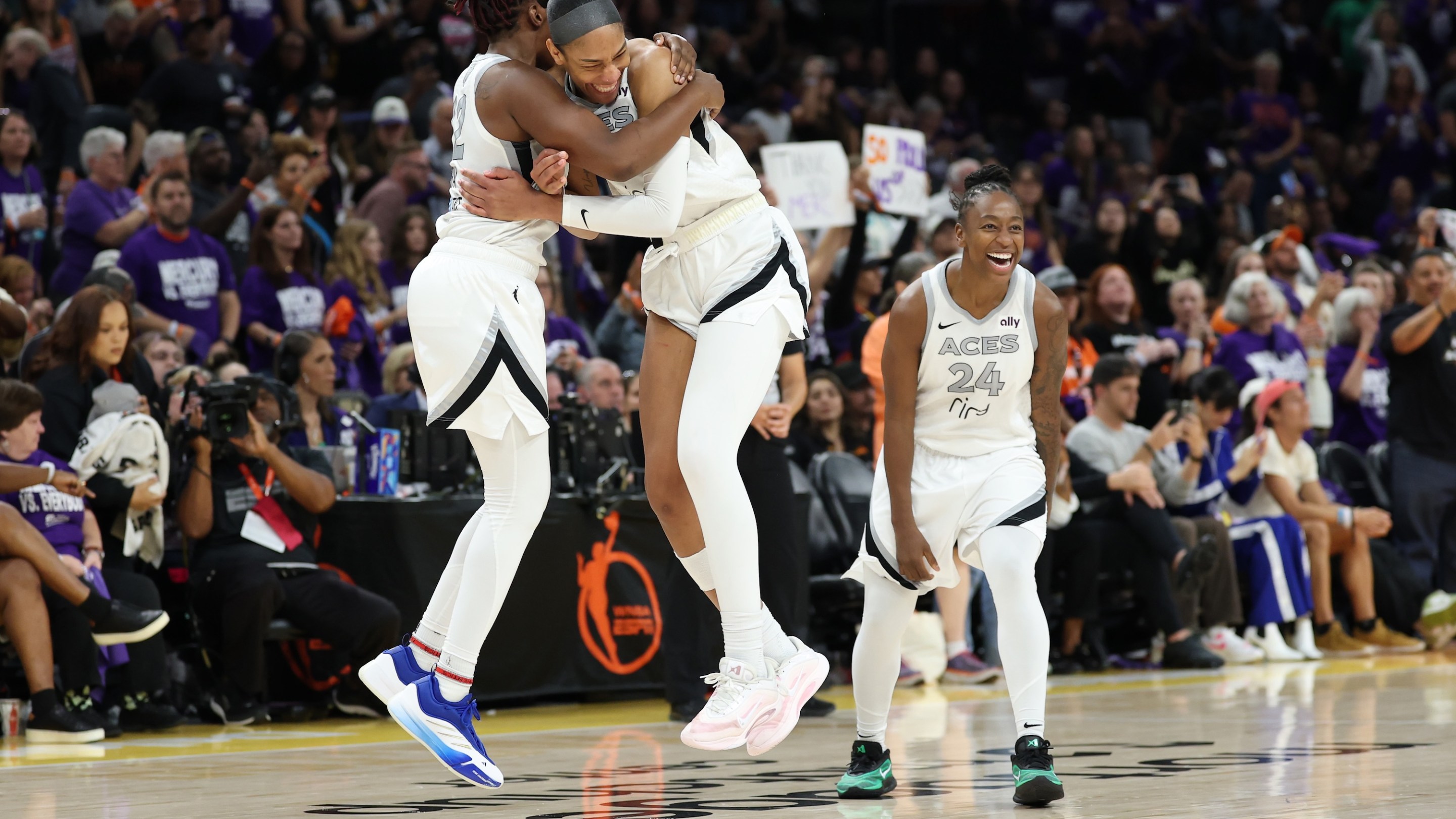 PHOENIX, ARIZONA - OCTOBER 10: A'ja Wilson #22 of the Las Vegas Aces celebrates with Chelsea Gray #12 and Jewell Loyd #24 after winning Game Four of the 2025 WNBA Playoffs finals at Mortgage Matchup Center on October 10, 2025 in Phoenix, Arizona. The Las Vegas Aces defeat the Phoenix Mercury 97-86 to win the championship. NOTE TO USER: User expressly acknowledges and agrees that, by downloading and or using this photograph, User is consenting to the terms and conditions of the Getty Images License Agreement. (Photo by Christian Petersen/Getty Images)