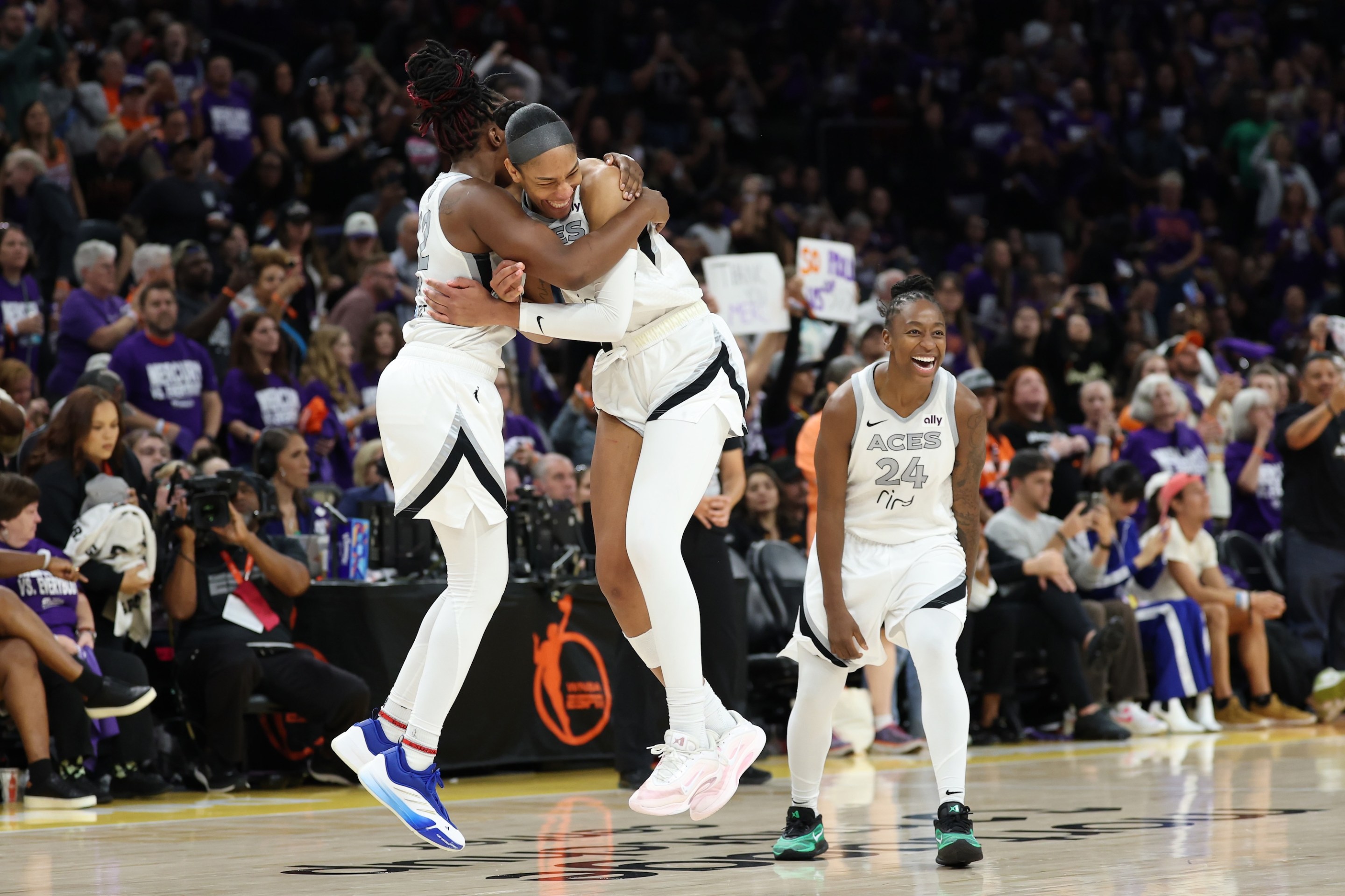 PHOENIX, ARIZONA - OCTOBER 10: A'ja Wilson #22 of the Las Vegas Aces celebrates with Chelsea Gray #12 and Jewell Loyd #24 after winning Game Four of the 2025 WNBA Playoffs finals at Mortgage Matchup Center on October 10, 2025 in Phoenix, Arizona. The Las Vegas Aces defeat the Phoenix Mercury 97-86 to win the championship. NOTE TO USER: User expressly acknowledges and agrees that, by downloading and or using this photograph, User is consenting to the terms and conditions of the Getty Images License Agreement. (Photo by Christian Petersen/Getty Images)