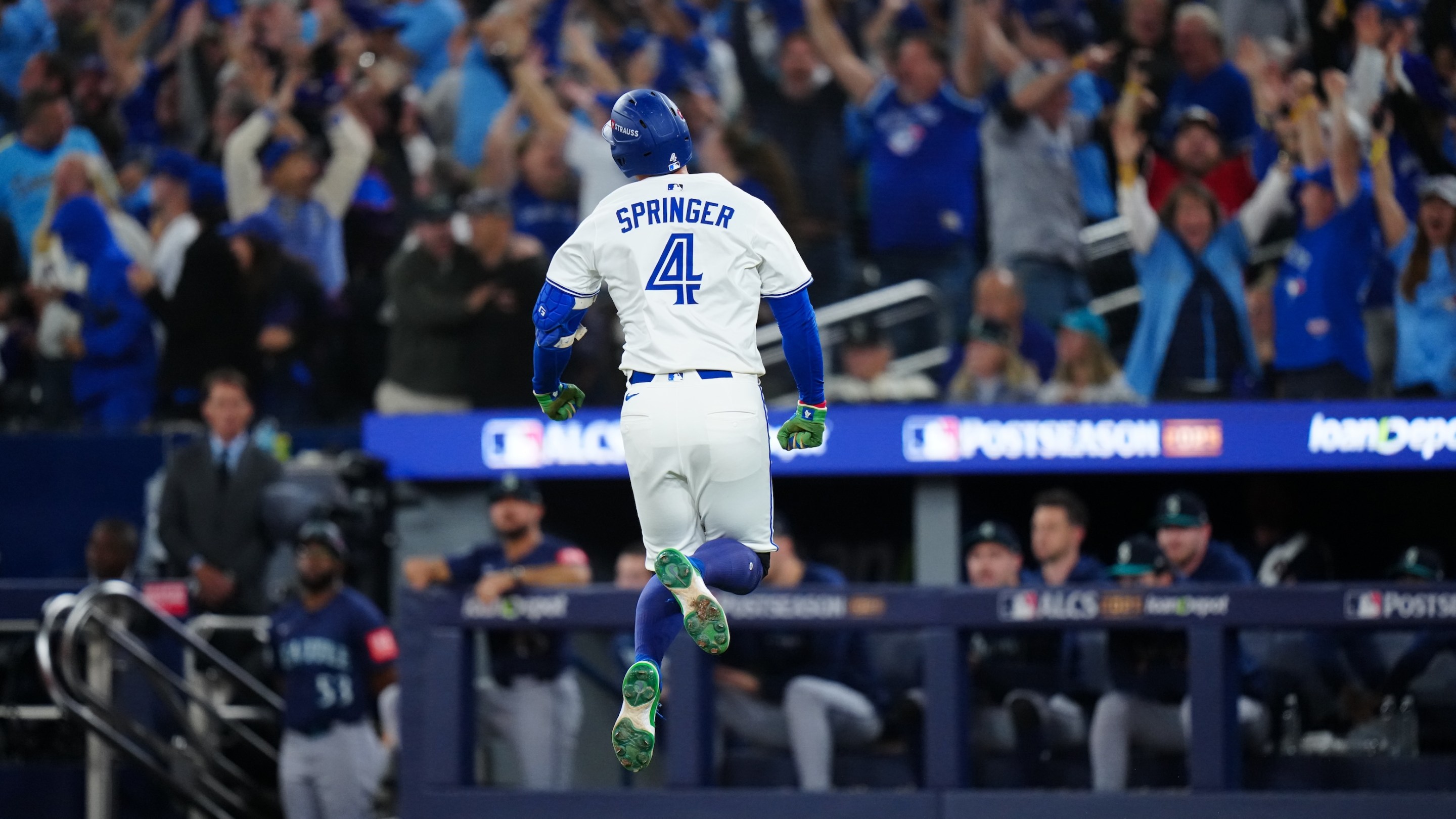 George Springer of the Toronto Blue Jays celebrates while rounding the bases after hitting a three-run home run to take the lead in the seventh inning during Game Seven of the American League Championship Series. He's like 18 inches off the ground and everyone in the stands is freaking out.