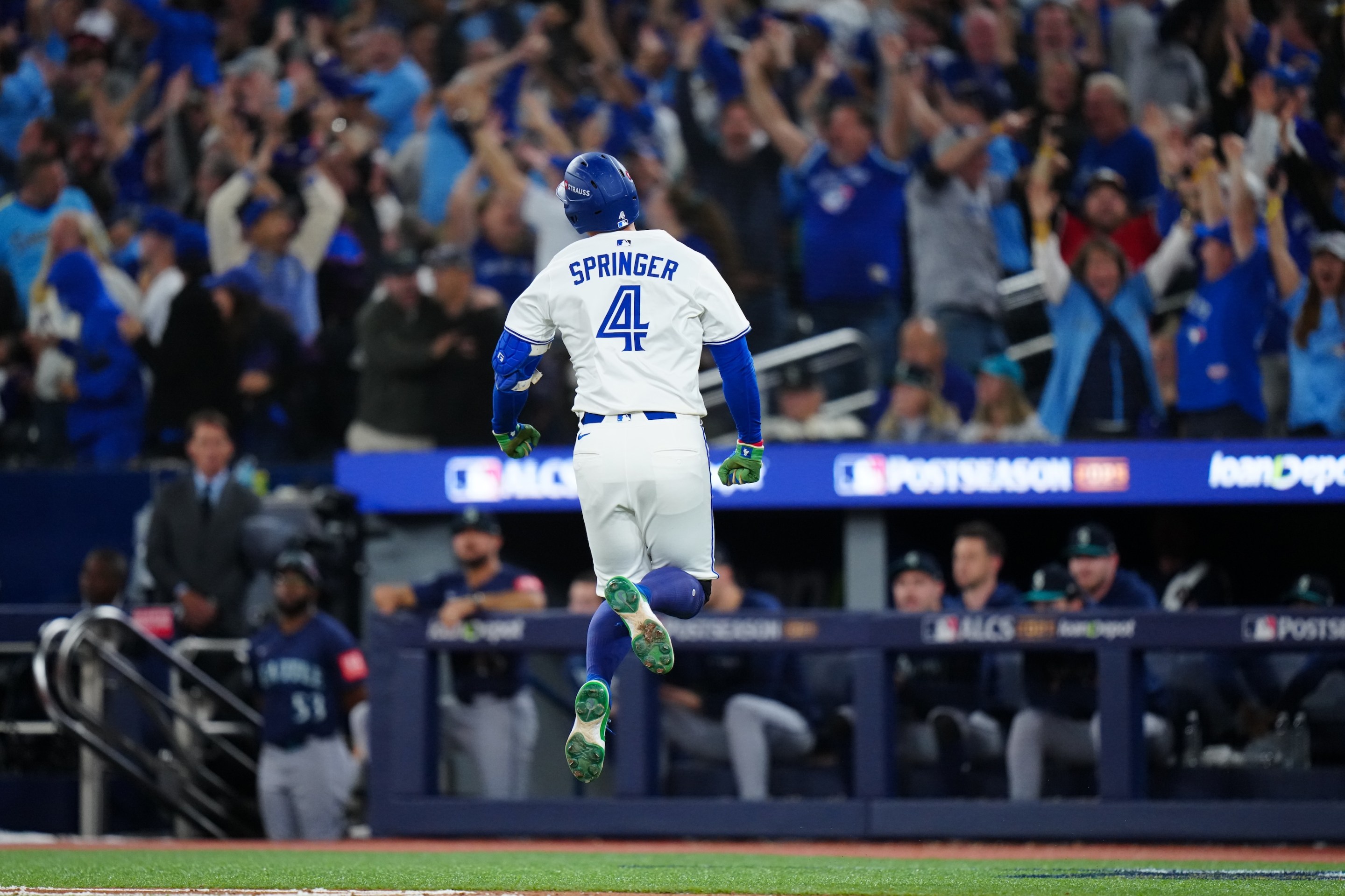 George Springer of the Toronto Blue Jays celebrates while rounding the bases after hitting a three-run home run to take the lead in the seventh inning during Game Seven of the American League Championship Series. He's like 18 inches off the ground and everyone in the stands is freaking out.