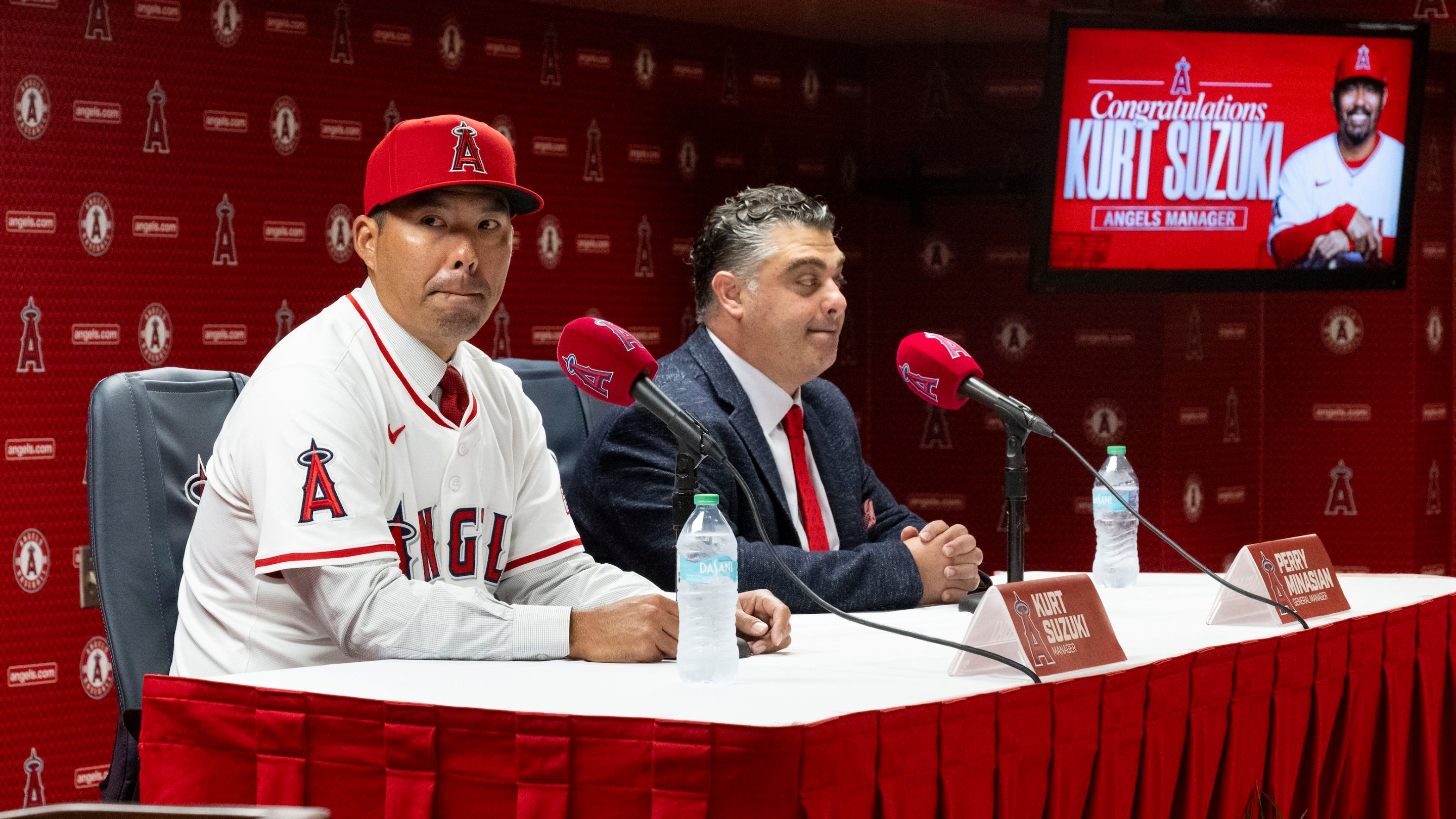 Kurt Suzuki, left, takes questions after being announced as the new manager of the Los Angeles Angels by General Manager Perry Minasian during a press conference at the stadium in Anaheim, CA on Wednesday, October 22, 2025. He looks kind of freaked out.