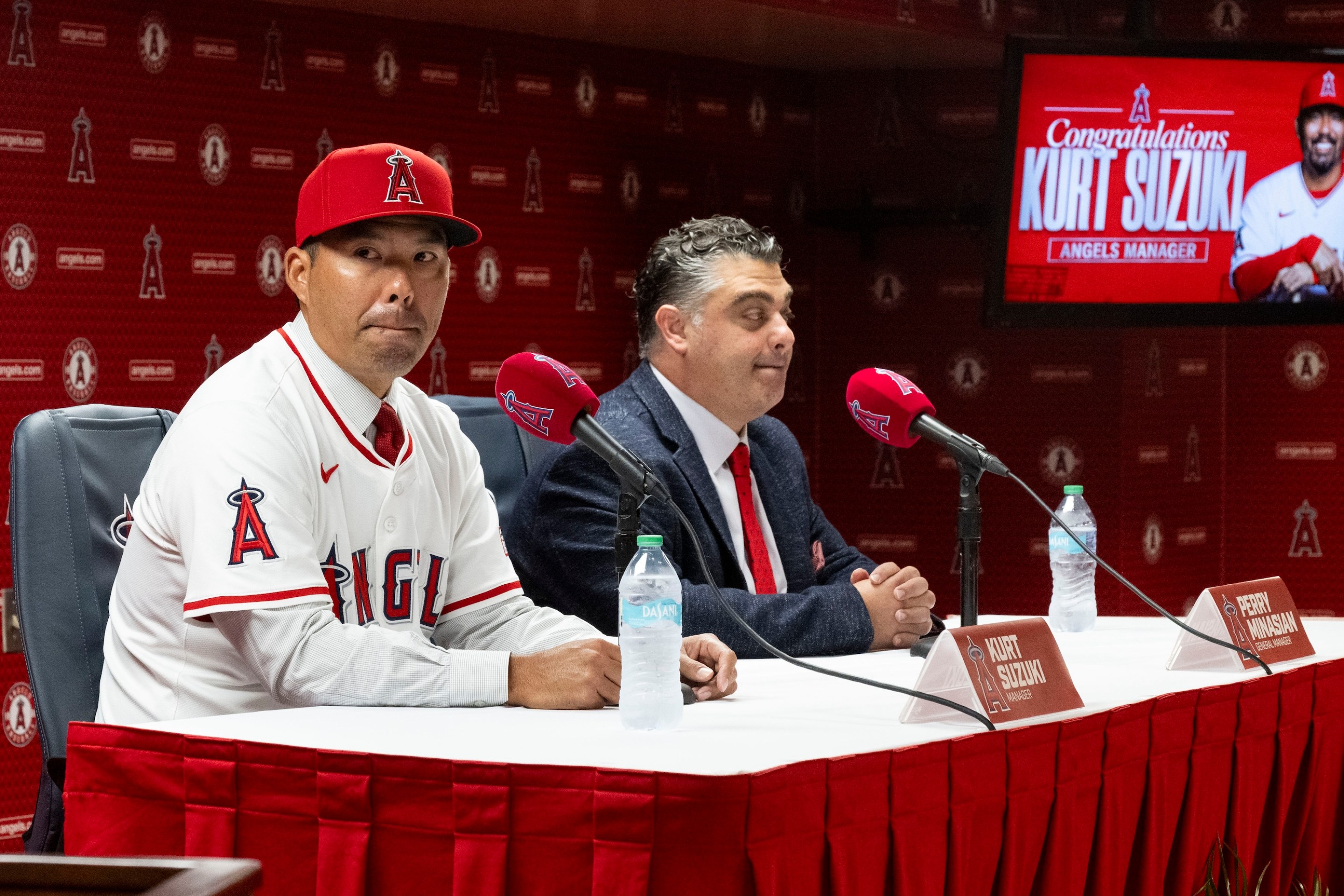 Kurt Suzuki, left, takes questions after being announced as the new manager of the Los Angeles Angels by General Manager Perry Minasian during a press conference at the stadium in Anaheim, CA on Wednesday, October 22, 2025. He looks kind of freaked out.