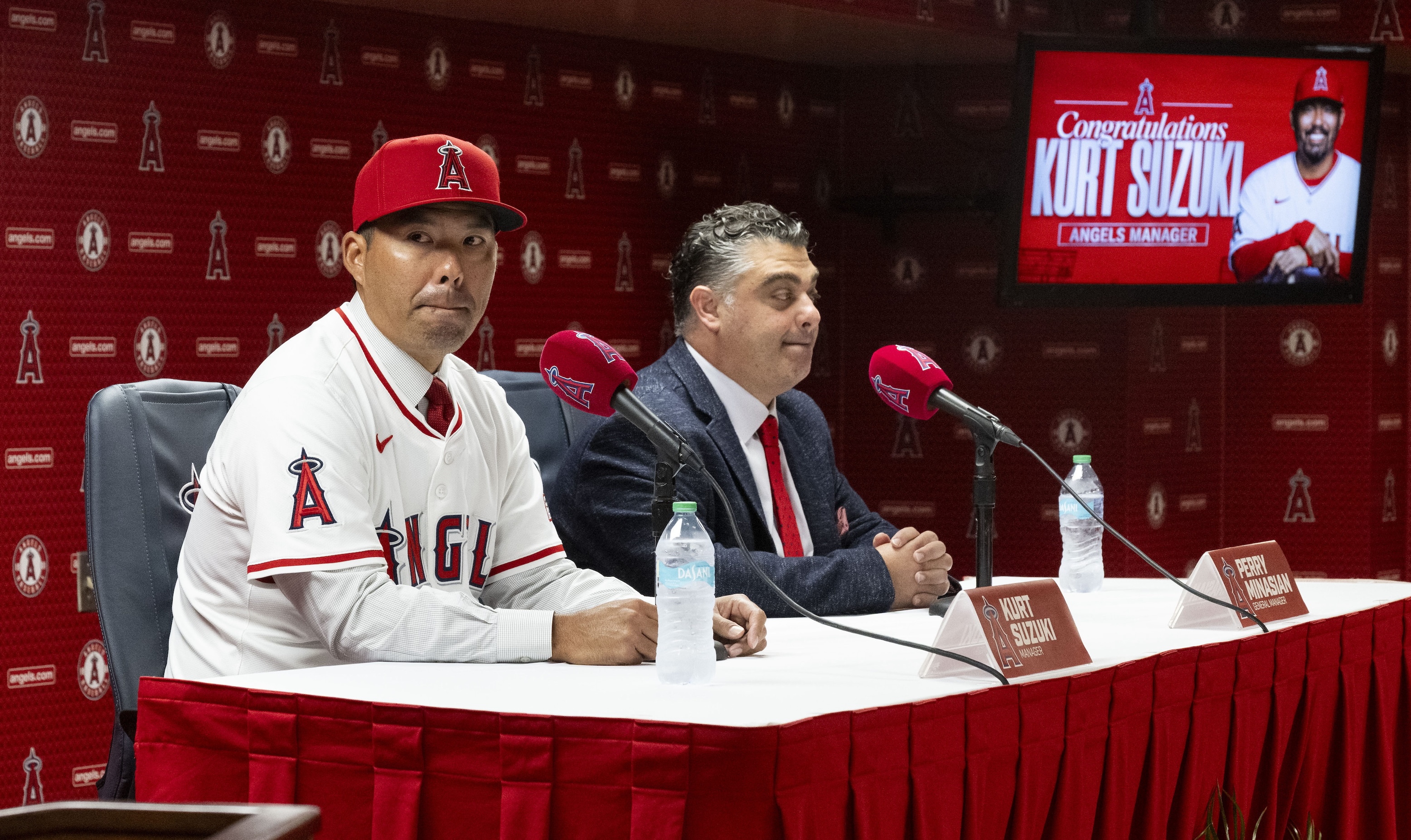 Kurt Suzuki, left, takes questions after being announced as the new manager of the Los Angeles Angels by General Manager Perry Minasian during a press conference at the stadium in Anaheim, CA on Wednesday, October 22, 2025. He looks kind of freaked out.