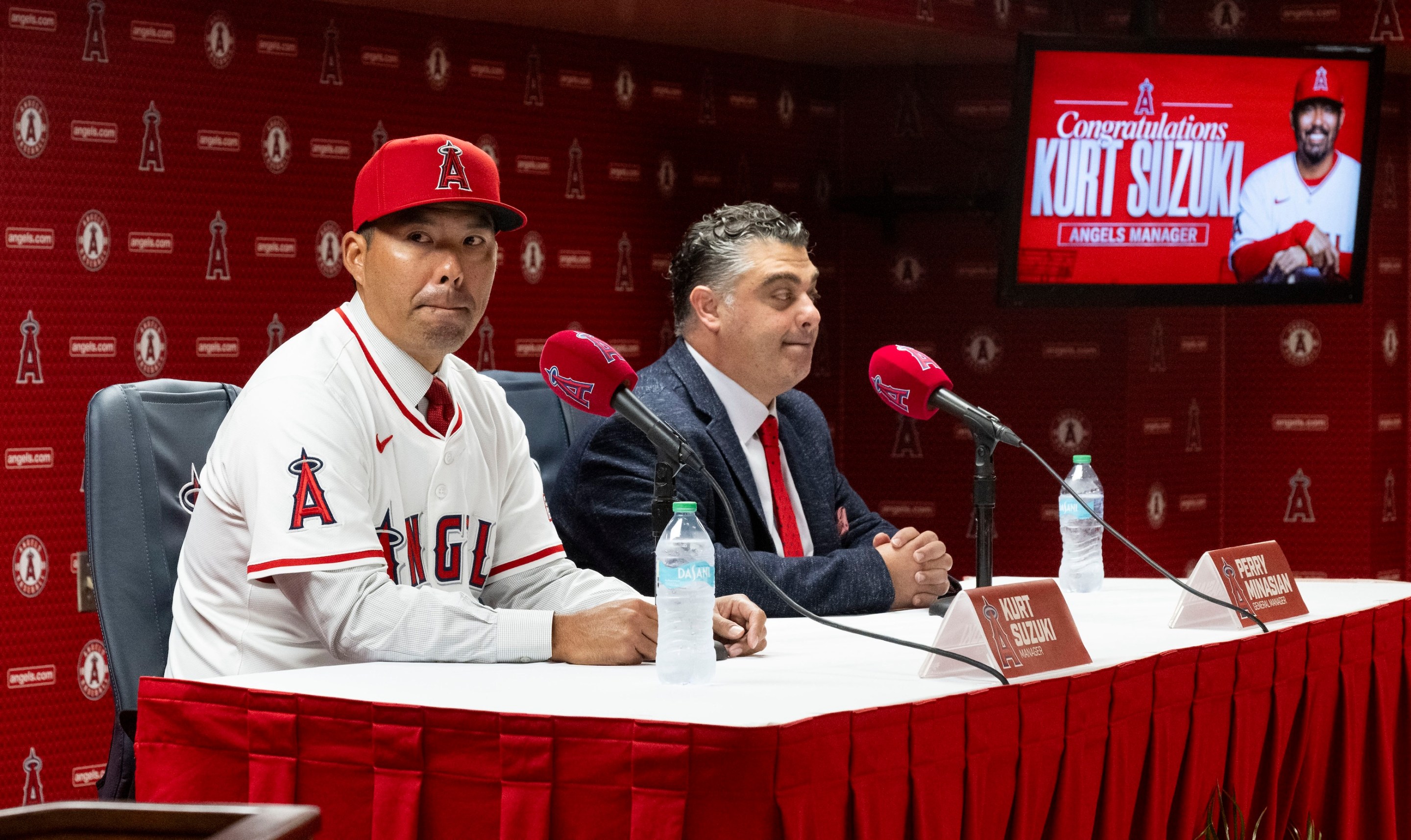 Kurt Suzuki, left, takes questions after being announced as the new manager of the Los Angeles Angels by General Manager Perry Minasian during a press conference at the stadium in Anaheim, CA on Wednesday, October 22, 2025. He looks kind of freaked out.