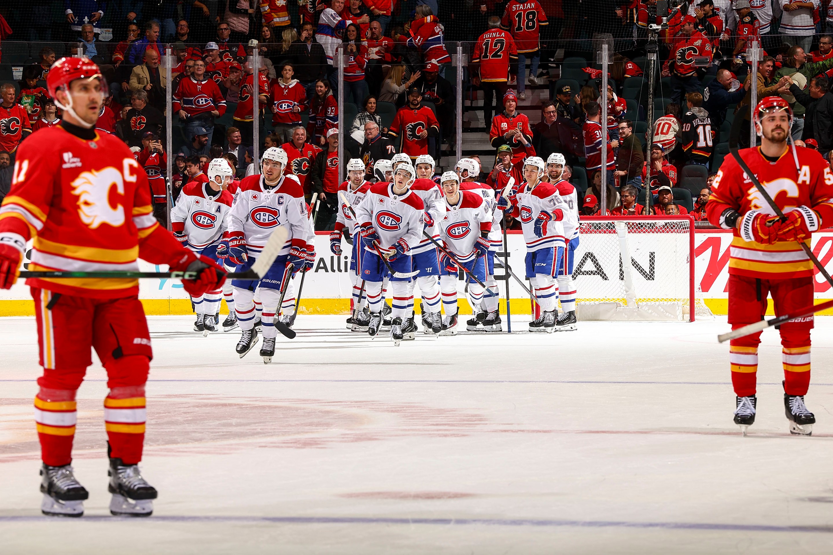 The Montreal Canadiens celebrate on ice after a win in overtime against the Calgary Flames at Scotiabank Saddledome on October 22, 2025 in Calgary, Alberta, Canada