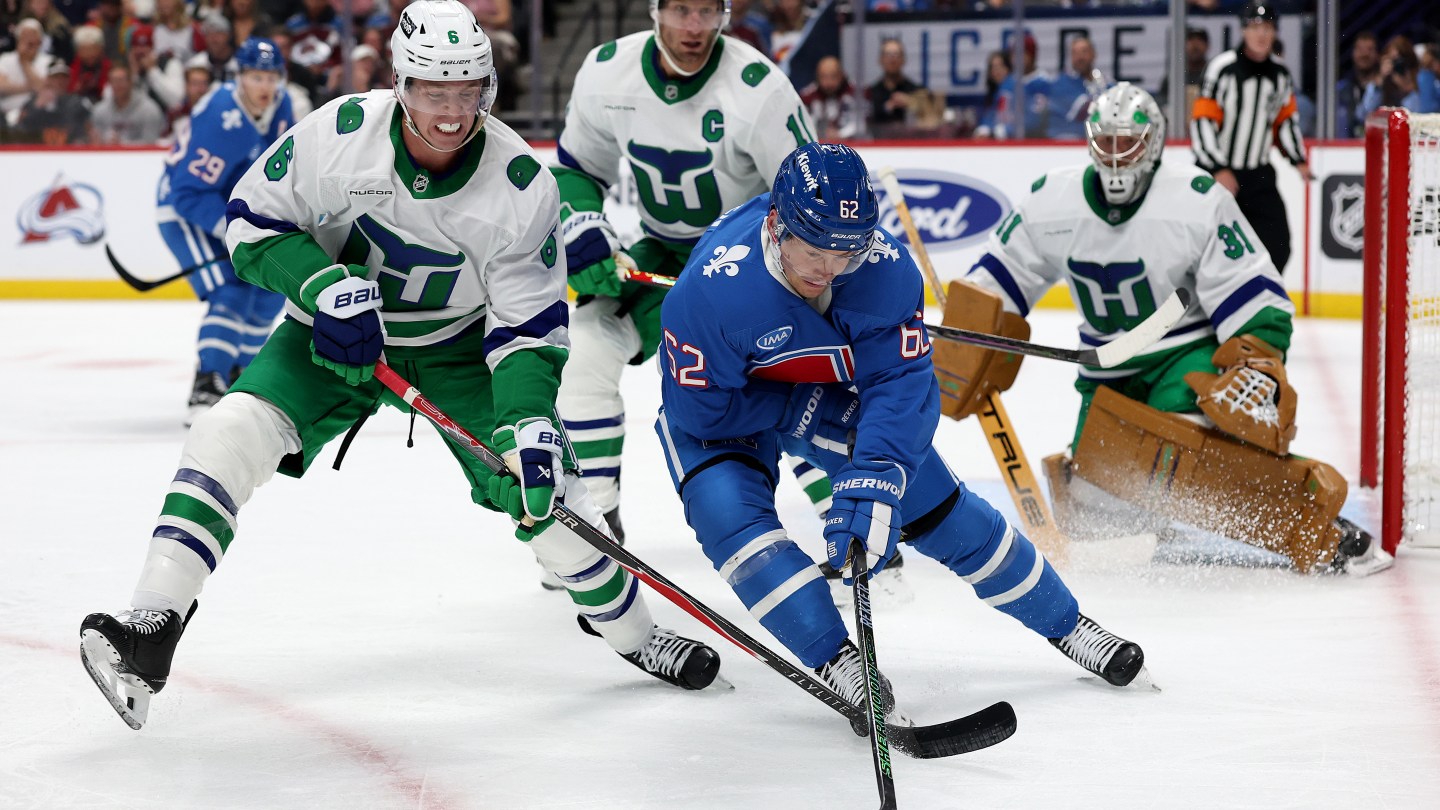 DENVER, COLORADO - OCTOBER 23: Mike Reilly #6 of the Carolina Hurricanes fights for control of the puck against Artturi Lehkonen #62 of the Colorado Avalanche in the second period at Ball Arena on October 23, 2025 in Denver, Colorado. (Photo by Matthew Stockman/Getty Images)
