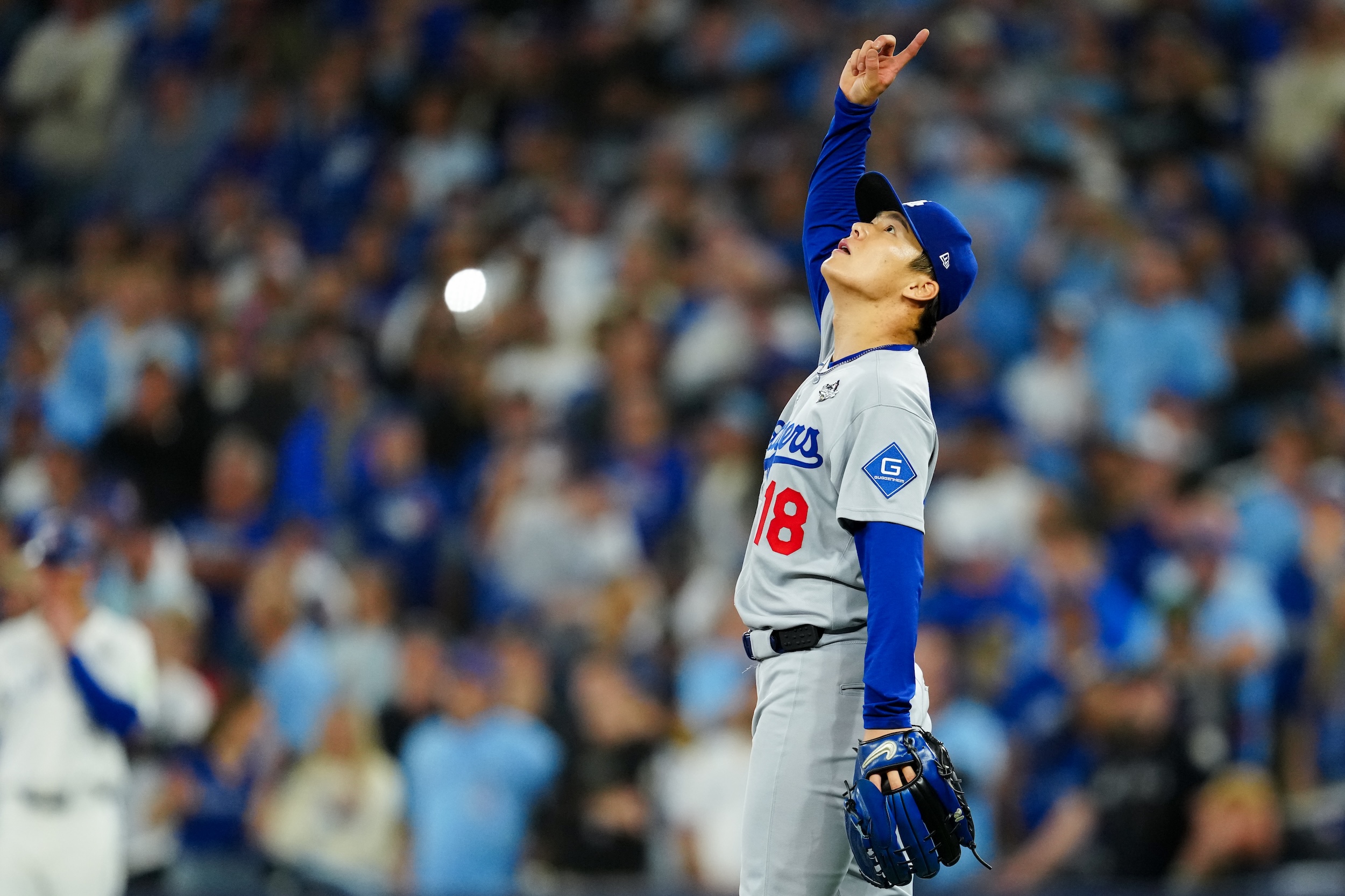 Yoshinobu Yamamoto of the Los Angeles Dodgers points to the sky after pitching a complete game and winning Game Two of the 2025 World Series.