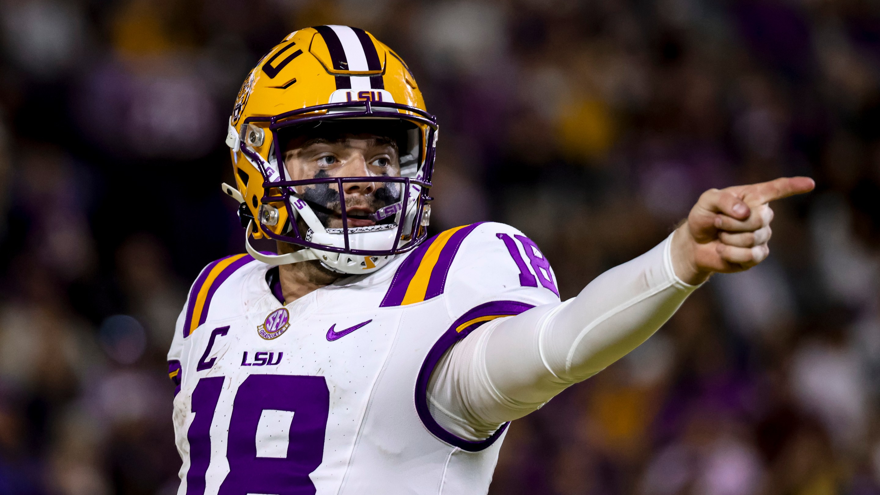 An LSU football player pointing in the distance.