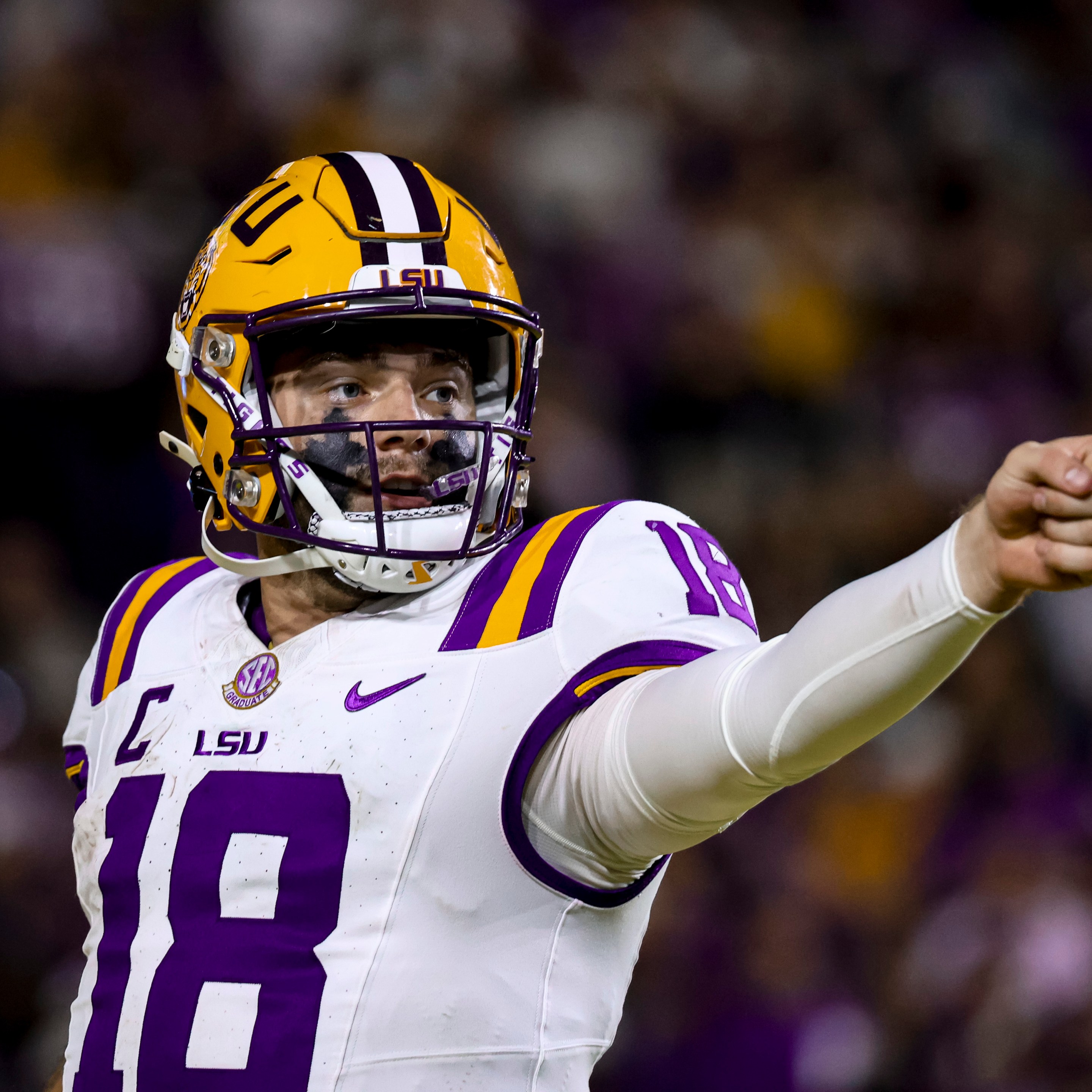 An LSU football player pointing in the distance.