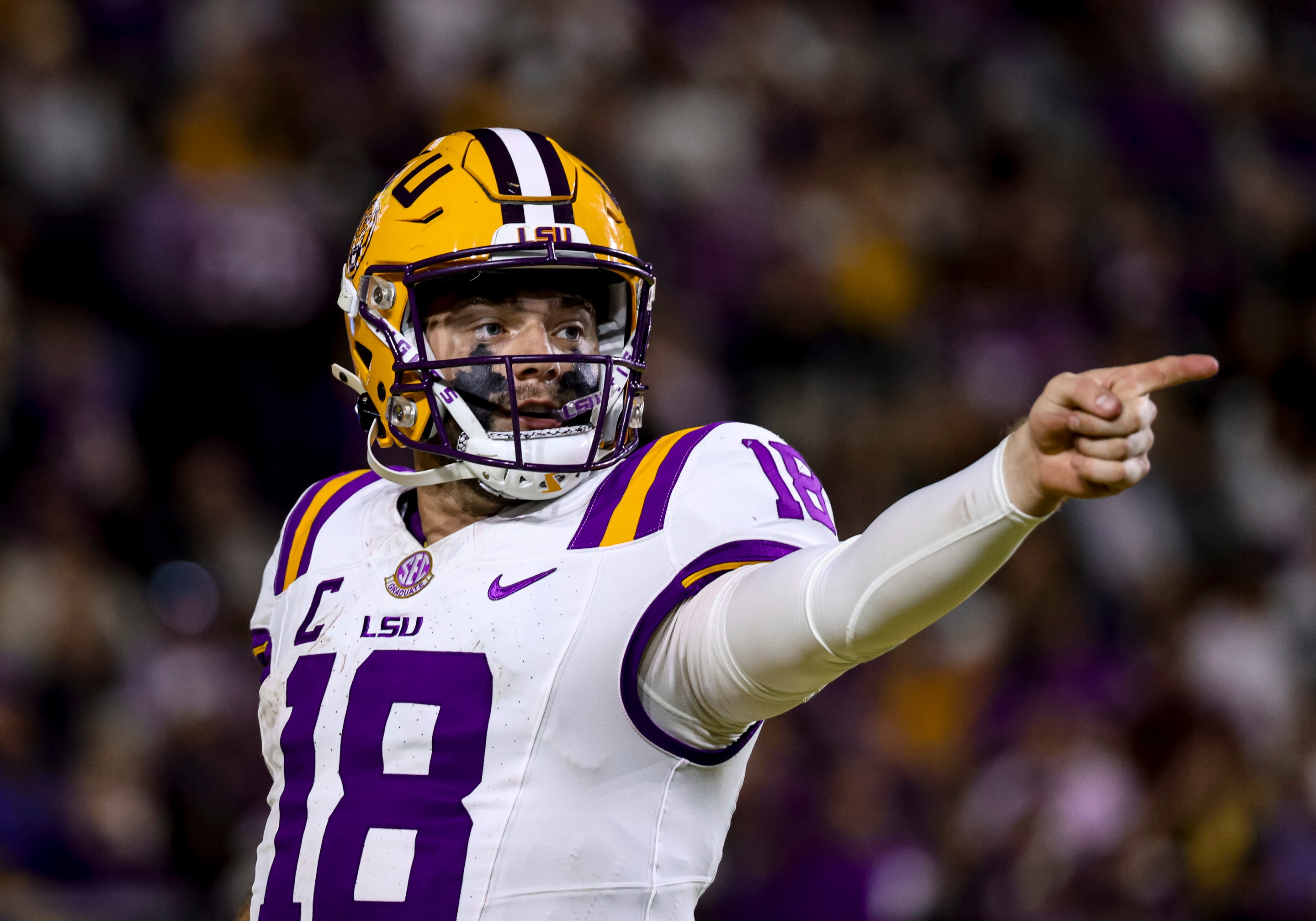 An LSU football player pointing in the distance.