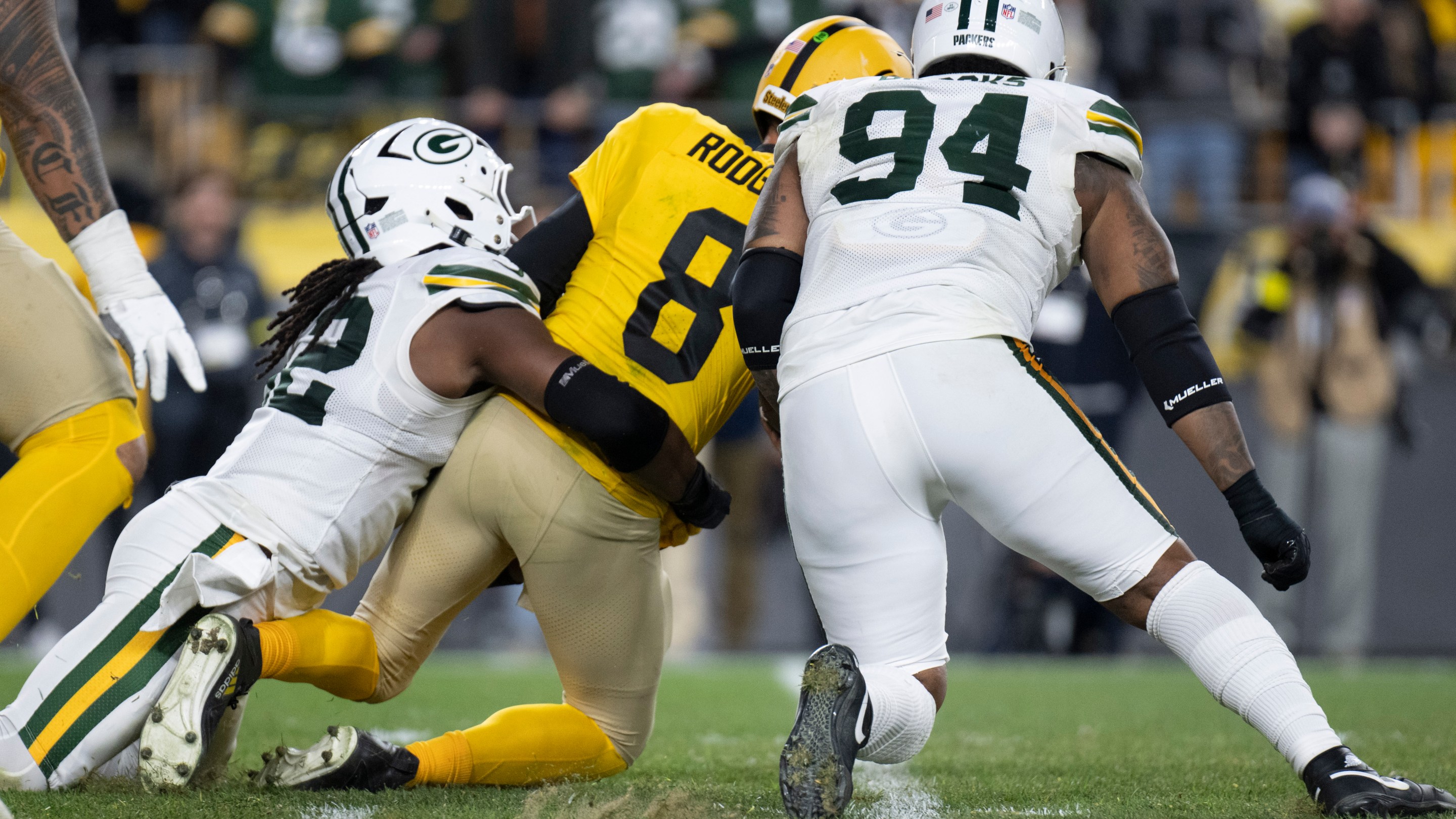 PITTSBURGH, PA - OCTOBER 26: Pittsburgh Steelers quarterback Aaron Rodgers (8) gets sacked by Green Bay Packers defensive end Rashan Gary (52) in the fourth quarter during the game between the Pittsburgh Steelers and Green Bay Packers at Acrisure Stadium on October 26, 2025 in Pittsburgh, PA.
