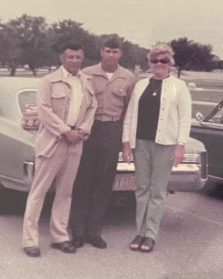 A photo of Mike Lucido with his parents, soon after he joined the Marines.