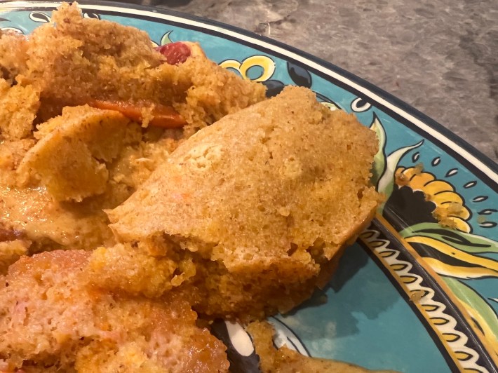 A close view of a half-baked, folded pudding.