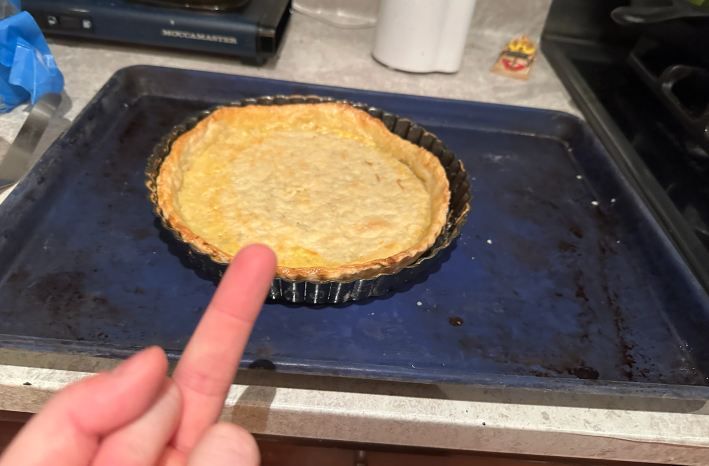 flipping off a pie crust which has clearly shrunk around the edges