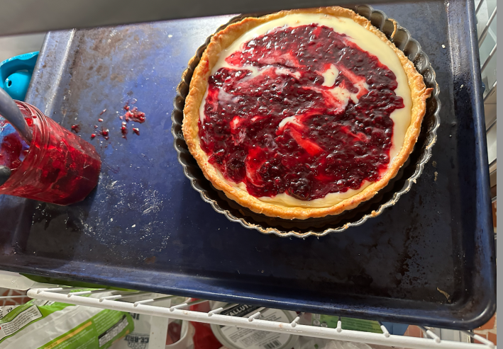 assembling pie in the freezer. berry jelly on white chocolate inside a pie crust