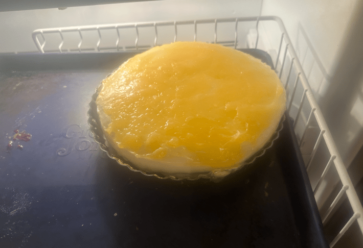 lemon gloop on top of a pie in the freezer