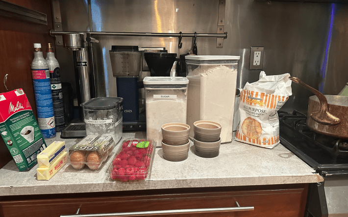 ingredients for the bake including raspberries, eggs, sugar, and flour