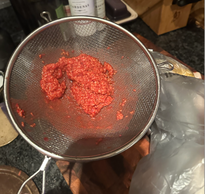 a sieve with raspberries that won't go through