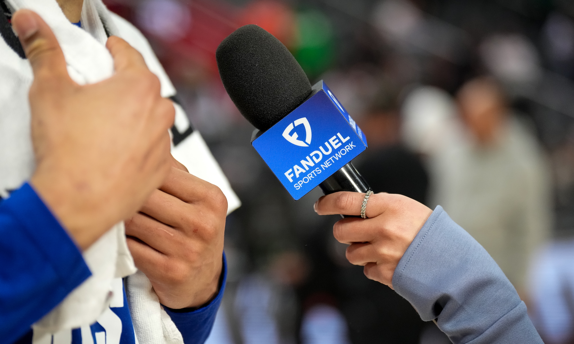 A detailed view of a hand holding a Fanduel Sports Network–branded microphone during an interview after the Detroit Pistons defeated the Boston Celtics on February 26, 2025 in Detroit, Michigan.