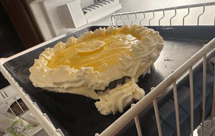 pie in freezer with whipped cream falling off