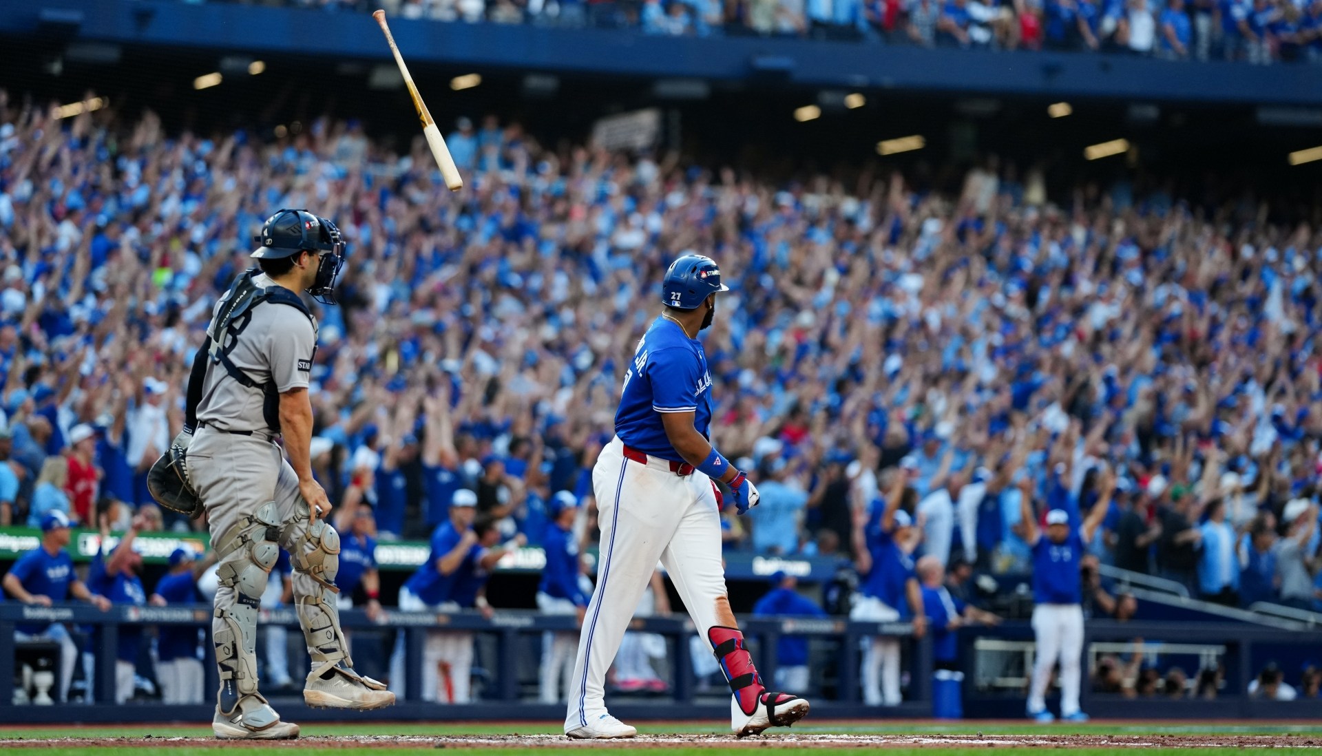 Vladimir Guerrero Jr. #27 of the Toronto Blue Jays tosses his bat after hitting a grand slam.