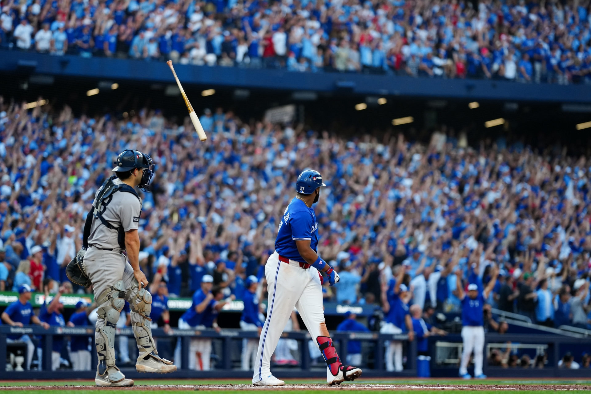 Vladimir Guerrero Jr. #27 of the Toronto Blue Jays tosses his bat after hitting a grand slam.