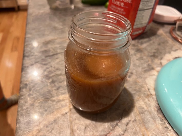 A small glass jar of cider caramel sauce.