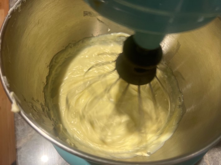 Custard in a stand mixer, with butter added.