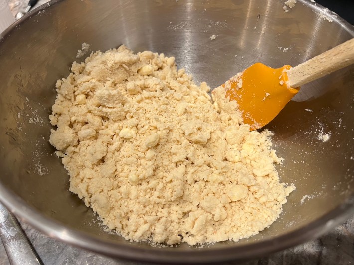 Dough clumping together in a bowl.