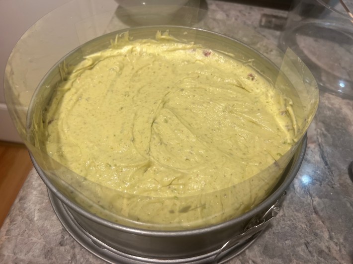 Sponge topped with mousseline, inside an acetate-lined springform pan.